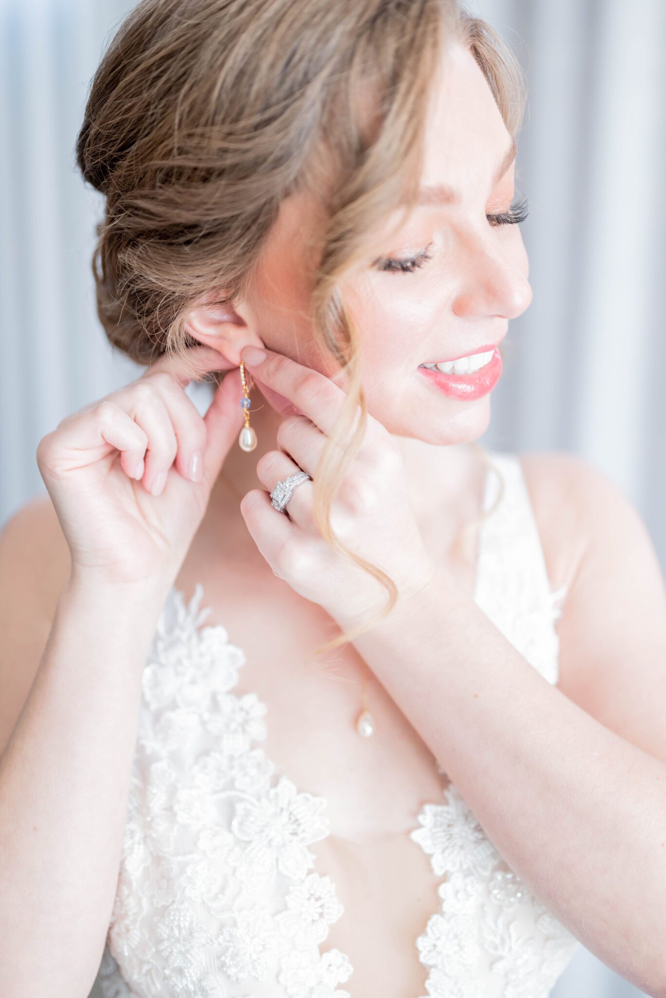 Bride putting on pearl and baby blue drop earrings in getting ready photo, bridal portrait inspiration, classic and timeless bridal make-up by Mas Make-Up Artist