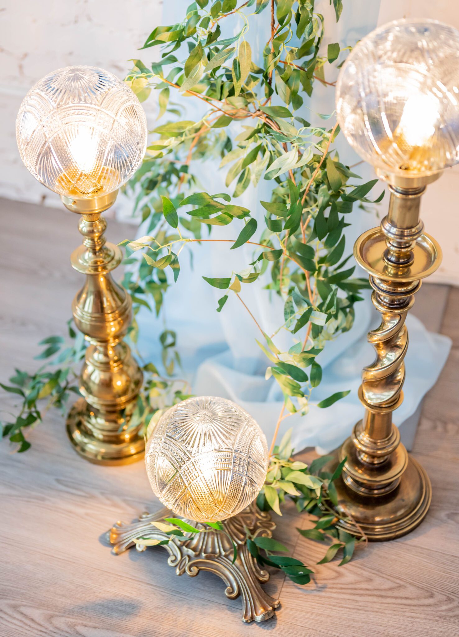 Nostalgic ambiance with vintage brass lighting decor by Coven Creative for indoor ceremony, french inspired wedding decor with baby blue accents, inspiring delicate greenery for ceremony decor 