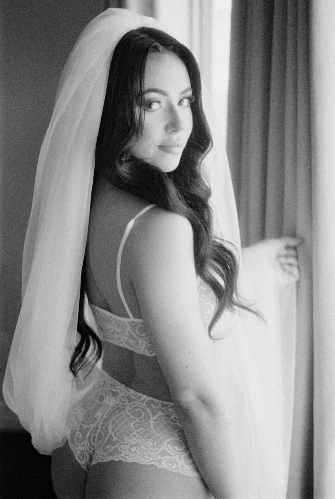 Elegant black and white bridal boudoir portraits, Intimate bridal photoshoot with bride wearing in white lingerie and veil