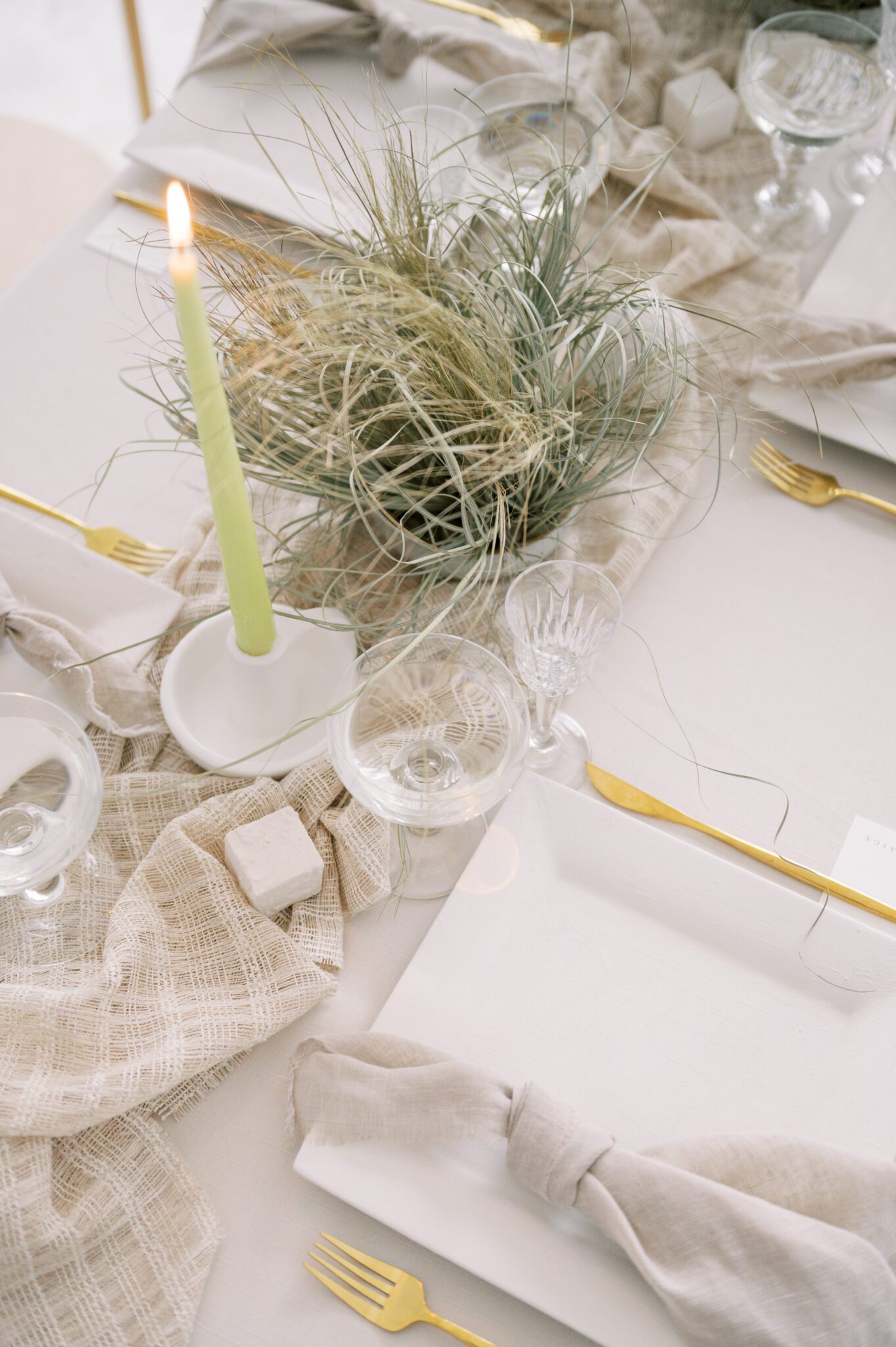 modern place setting featuring nature-inspired textures, grass centrepieces featuring white and beige table scape