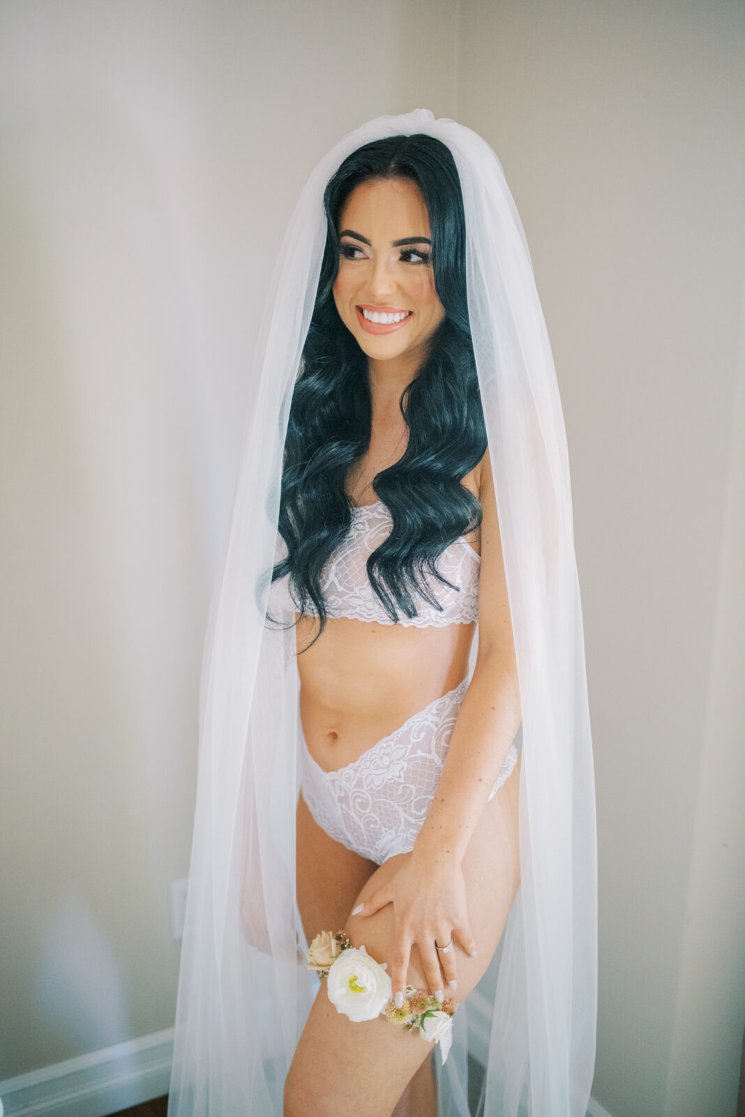 bridal boudoir portraits with veil, intimate bridal portrait with floral garter in a fall theme colour palette, white lace wedding day lingerie for bridal photoshoot