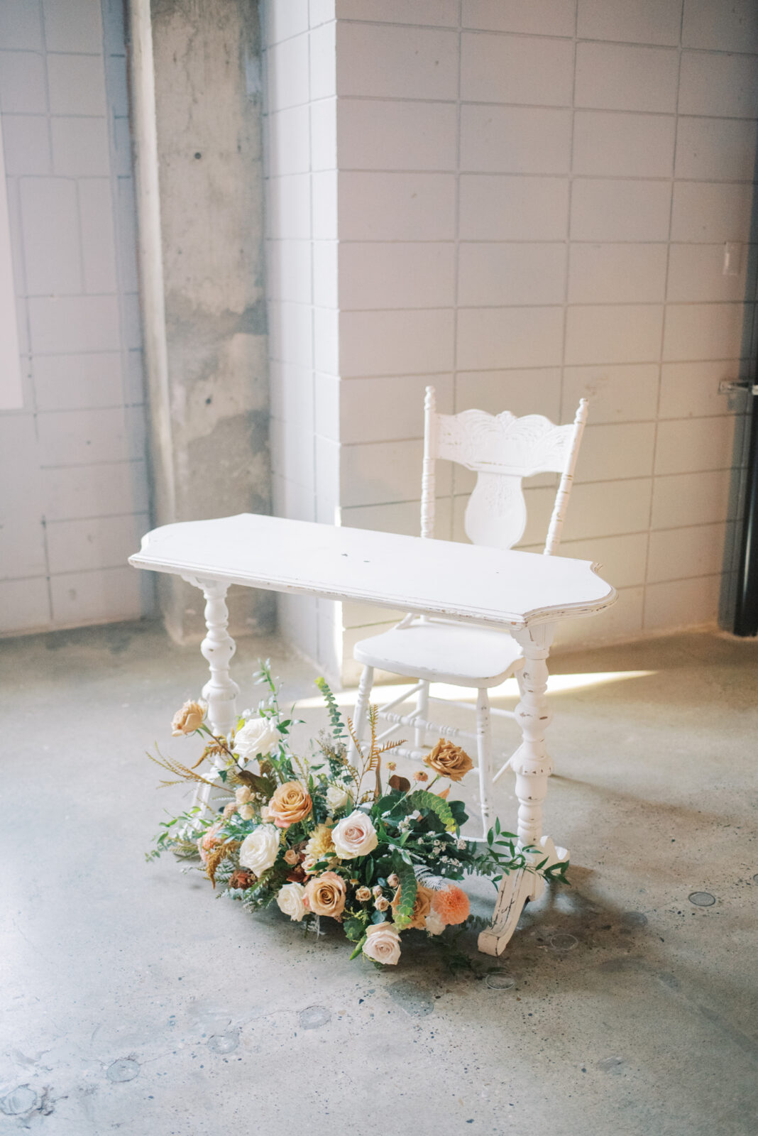 wedding license signing table in all white with a fall floral arrangement in warm hues and rich tones