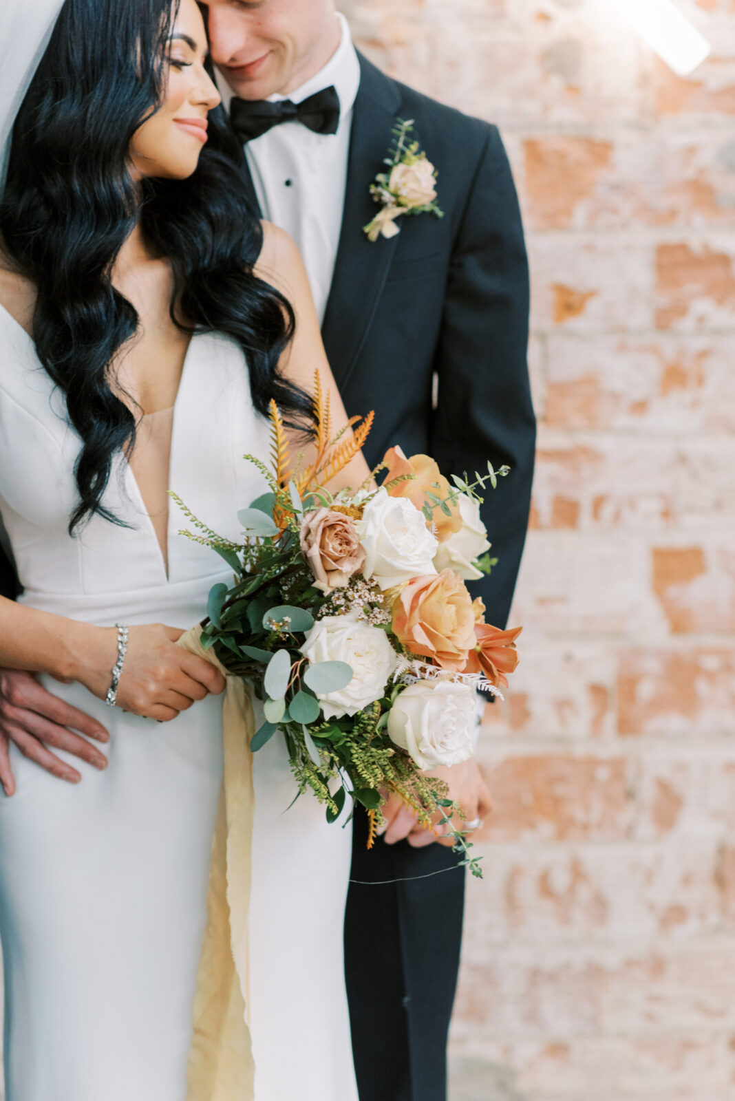 Chic and modern bridal attire ideas, bride and groom portraits. fall-toned florals and greenery for bridal bouquet 