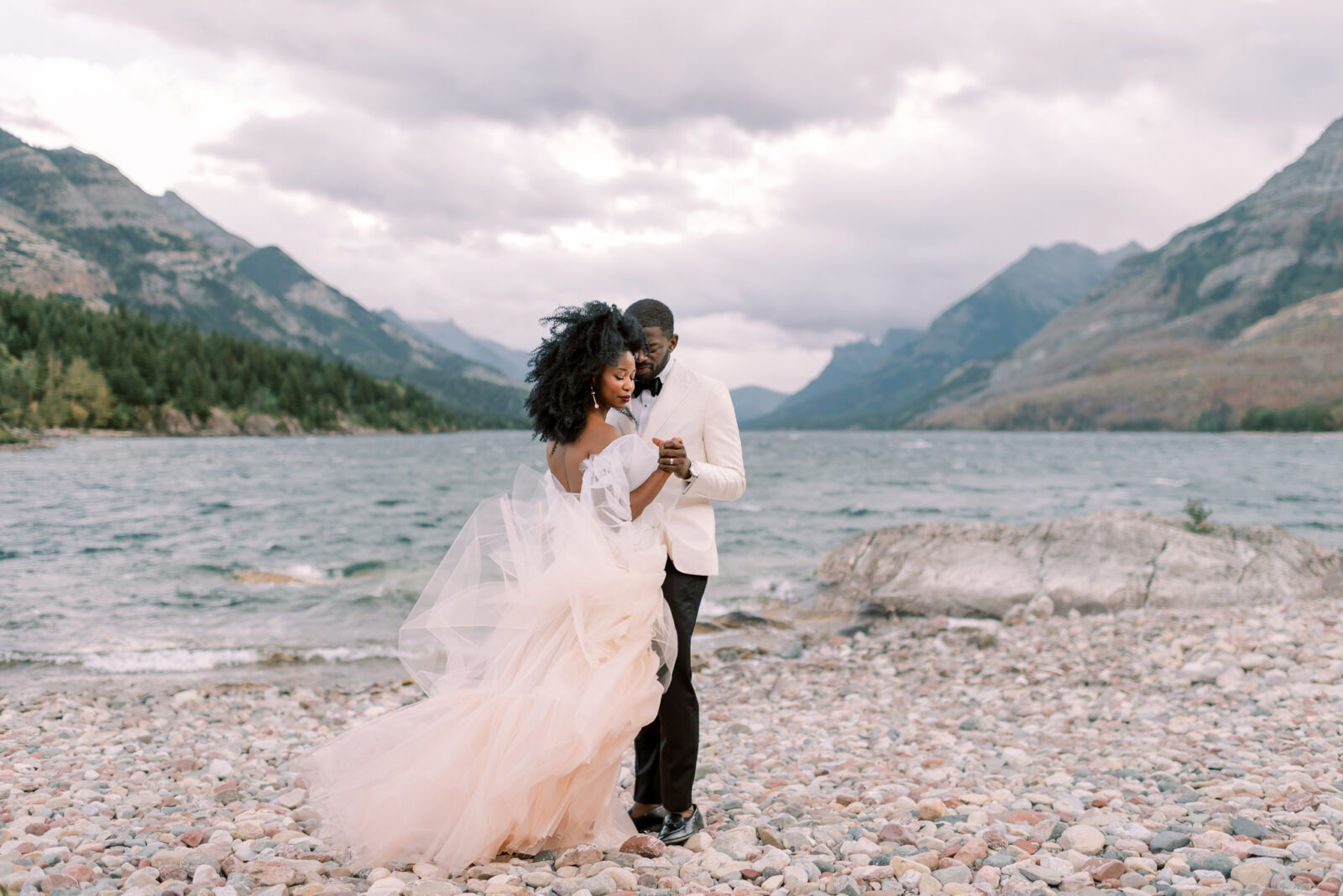 Intimate Elopement in Waterton Alberta, bride wearing blush wedding dress by Alexandra Victoria Rose, mountain lakeside couples portrait inspiration