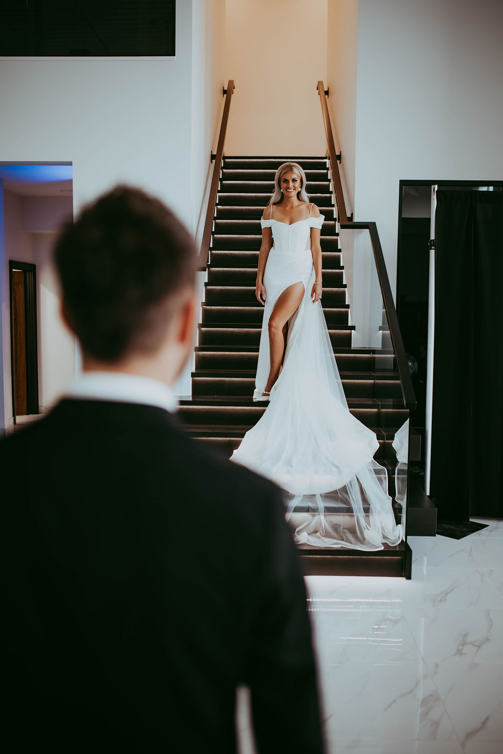 Bride and groom first look at modern, glam Red Deer wedding, bride in wedding gown with slit, wedding venue inspiration. 