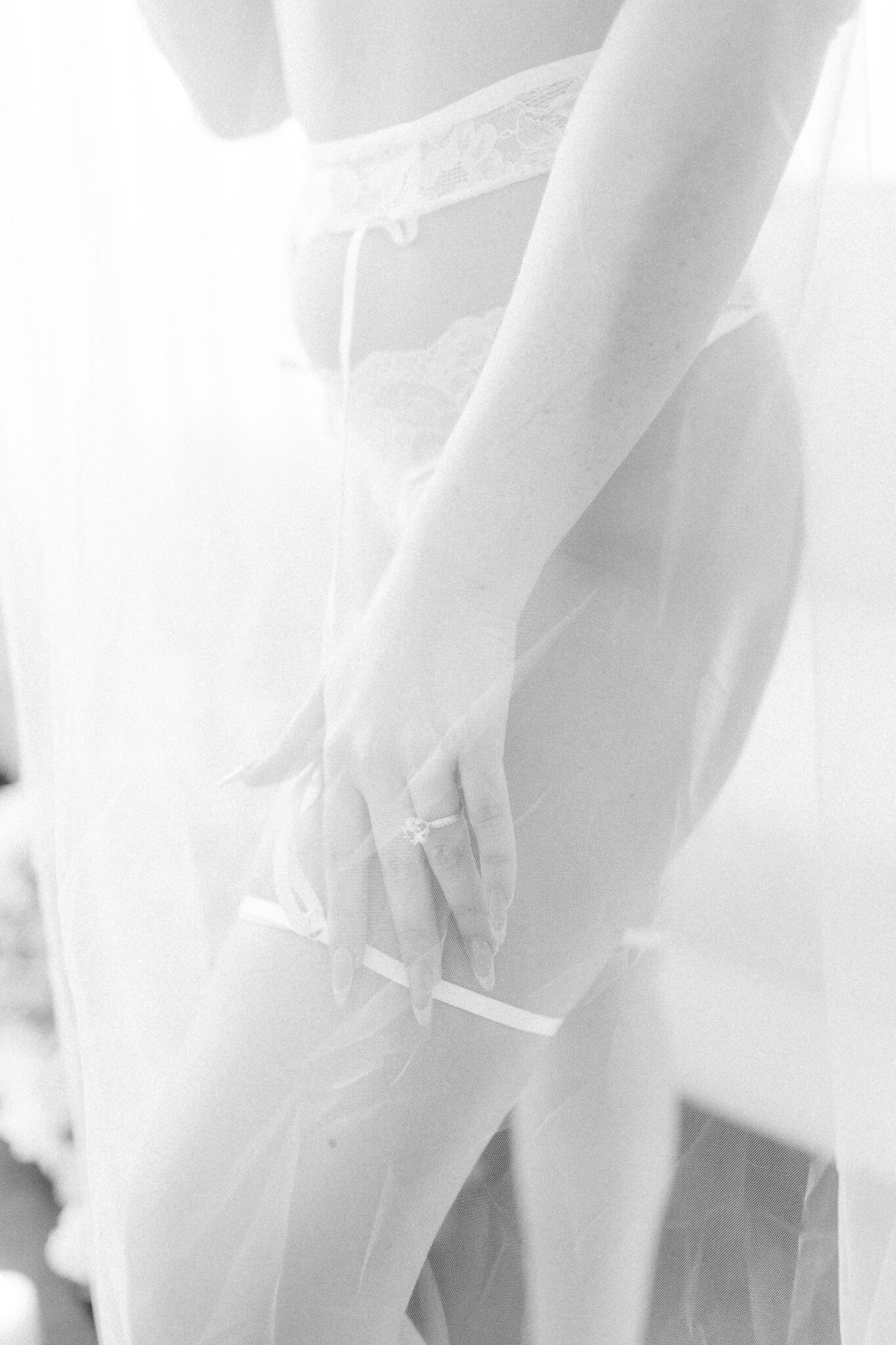 Black and white fine art bridal boudoir portrait featuring long wedding veil, intimate portraiture by Tara Jen Photo, bridal boudoir advice