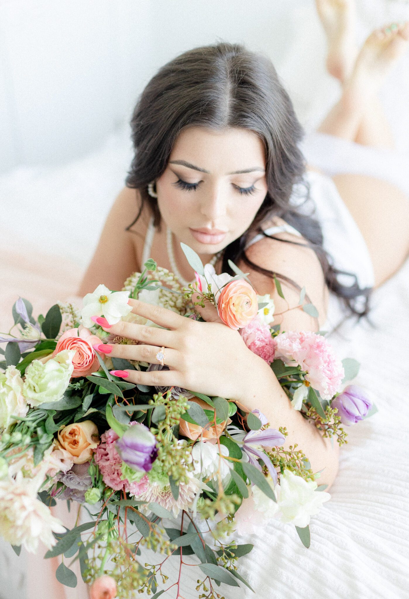 Fine art boudoir photography featuring feminine blush bridal bouquet by Fairydell Creek CO, romantic bridal makeup by Summer Glow Beauty, spring floral bridal boudoir inspiration, bridal boudoir advice