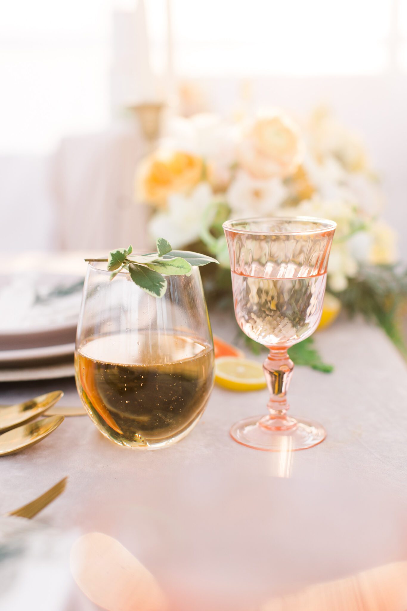 Summer tented wedding reception ideas, yellow and peach spring inspired floral arrangements, custom pink glassware, plates, and stemware, captured by Kayla Lynn Photography