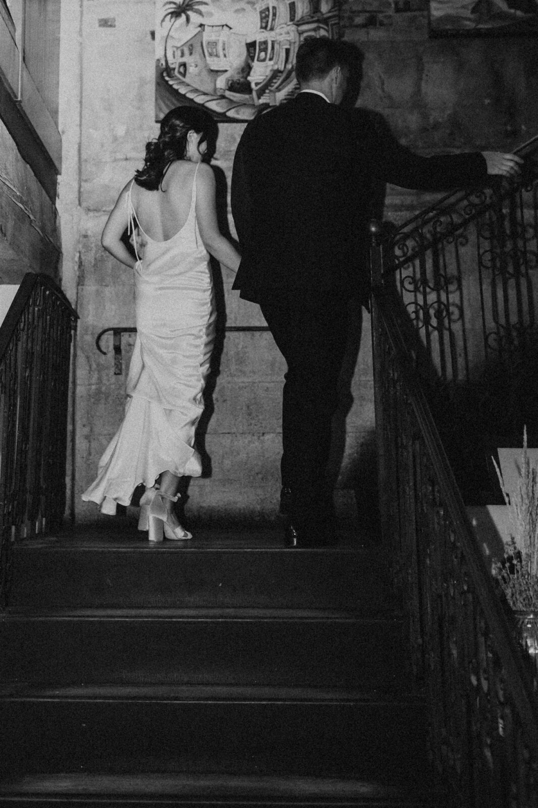 Black and white image of couple walking. Downtown Vancouver wedding photography by Abigail Eveline Photography.