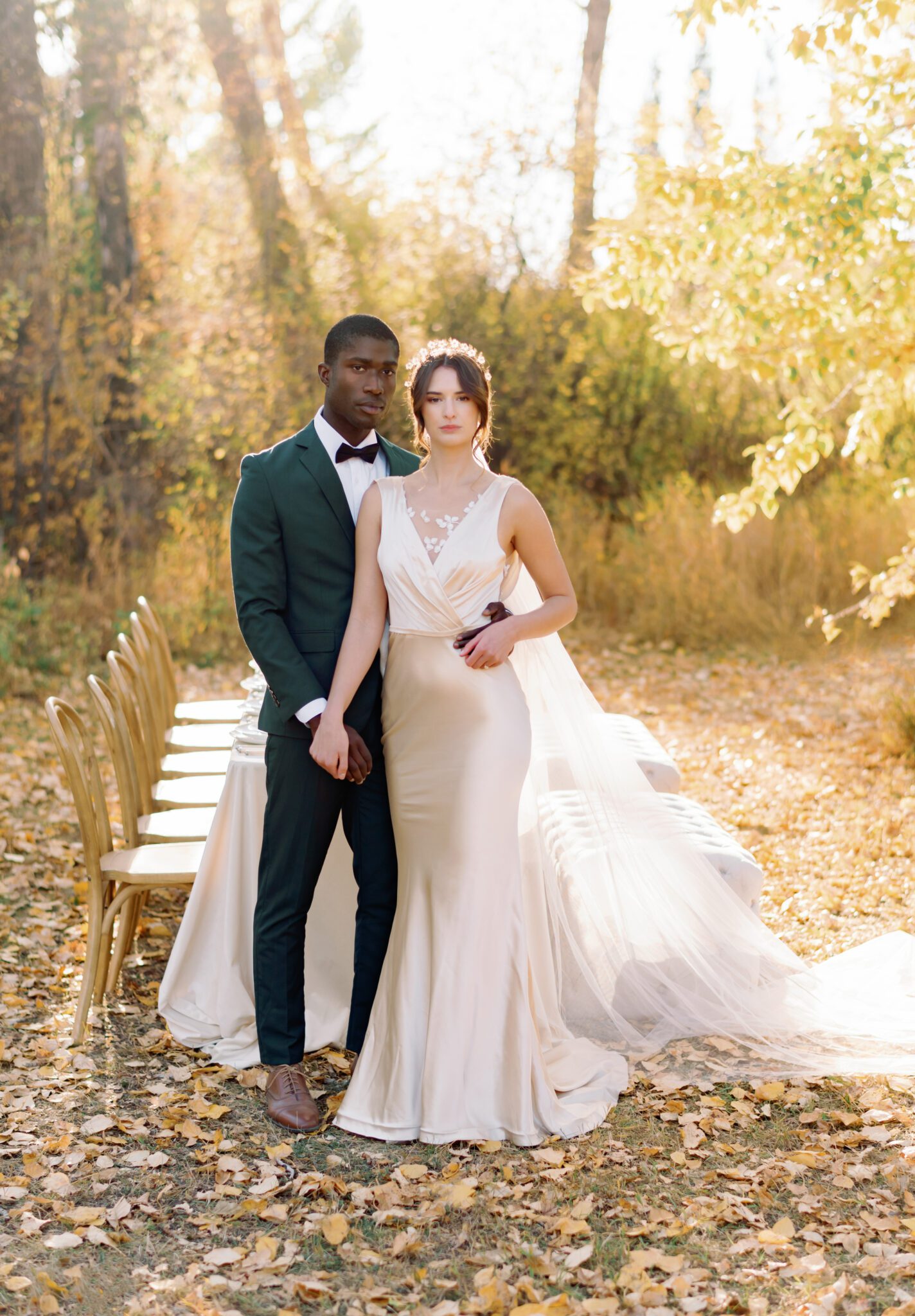 Fine art wedding photography by Kaity Body. Fall inspired wedding featuring emerald green suit and satin bridal gown with lace detail. 