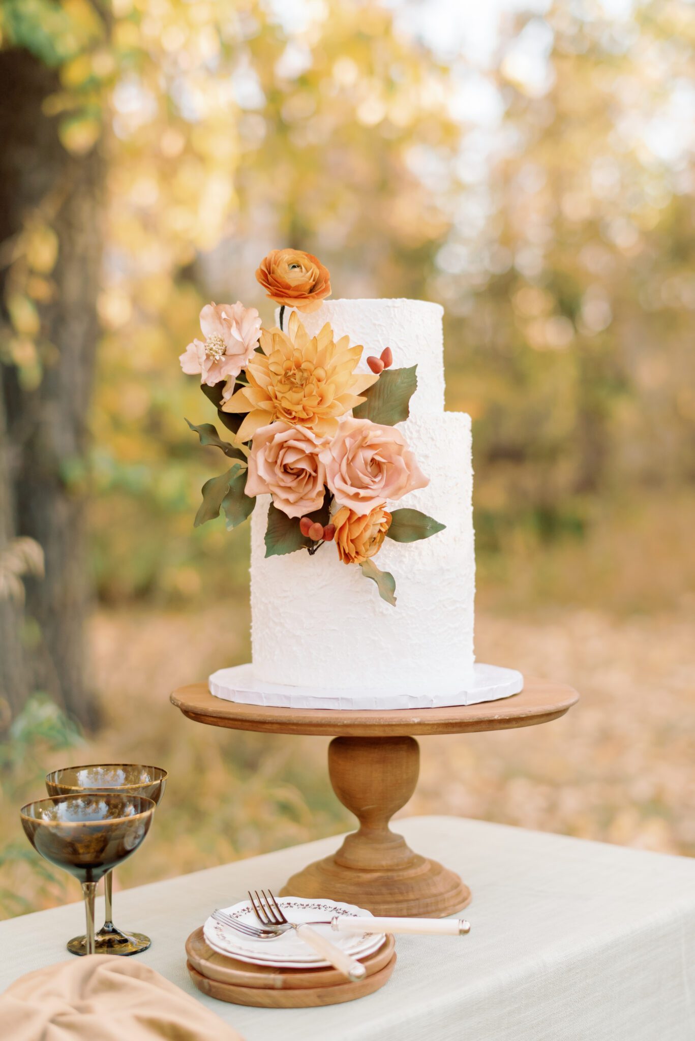 Fall inspired two-tier textured wedding cake with handmade sugar flowers, created by Yvonne's Delightful Cakes.