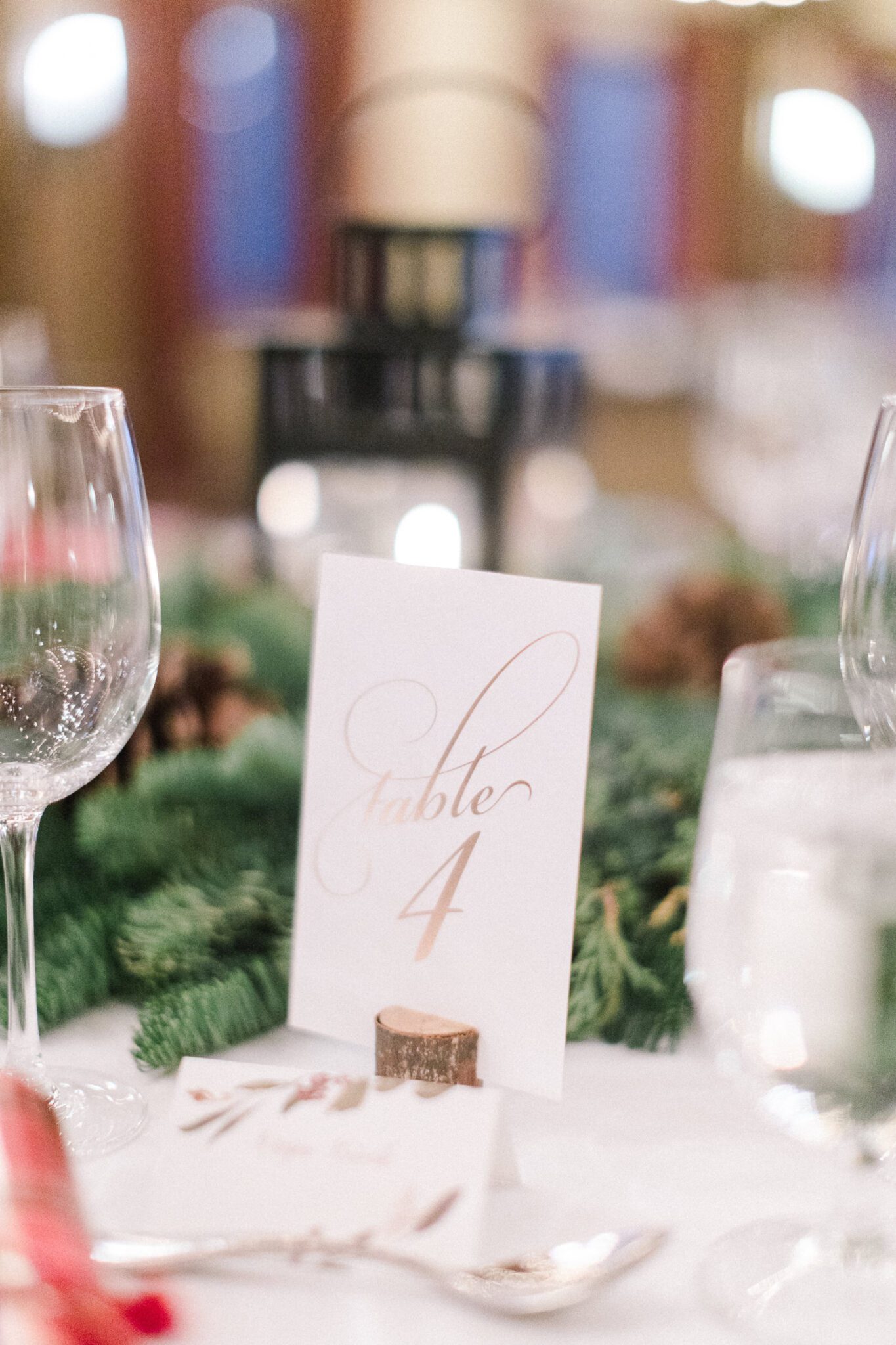 Winter-inspired tablescape, with handwritten, gold table numbers, winter wedding inspiration. 