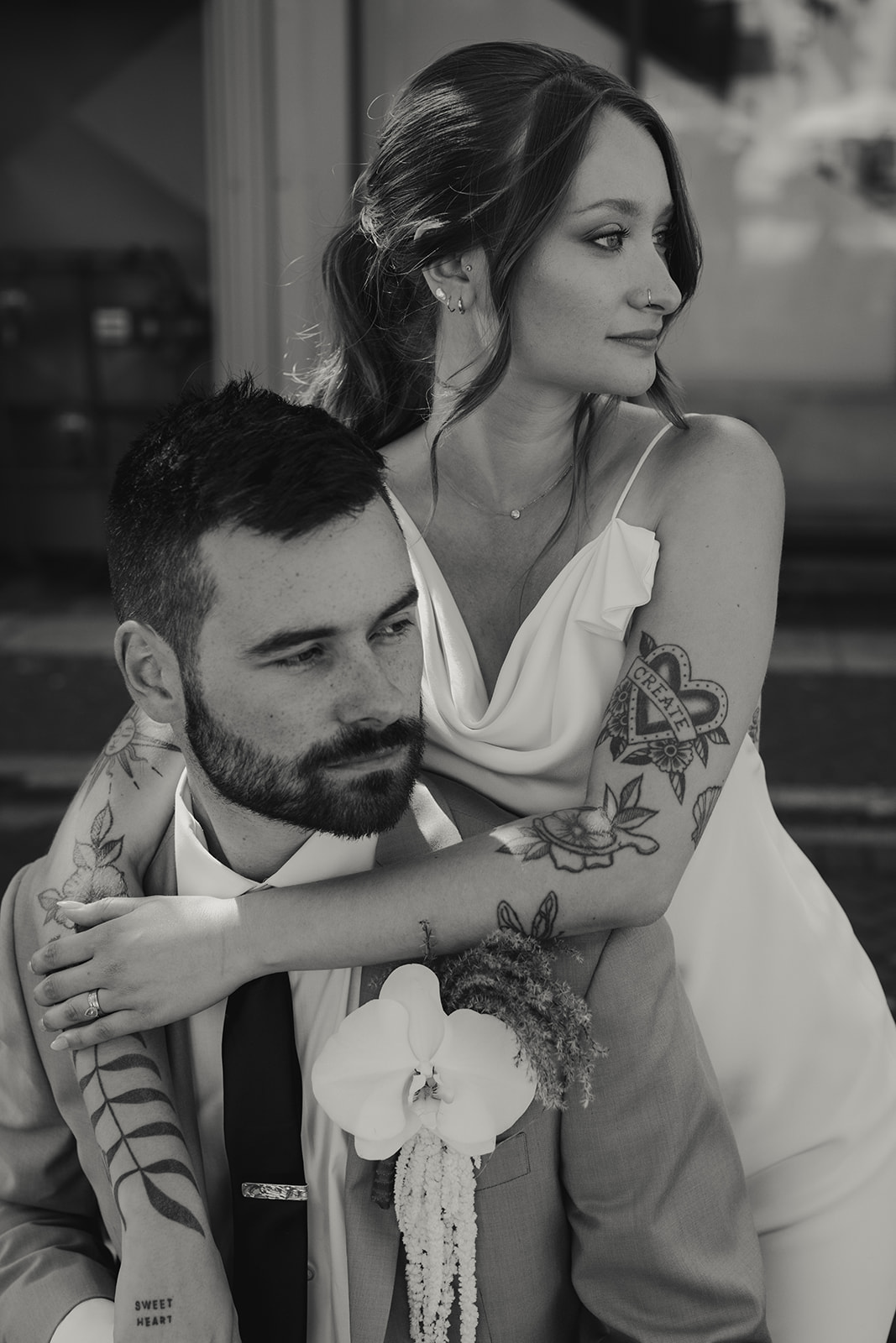Moody bride and groom portrait captured by Jeff and Cat of The Apartment Photo. Bride wearing sleek satin gown with low back by Savannah Miller. 