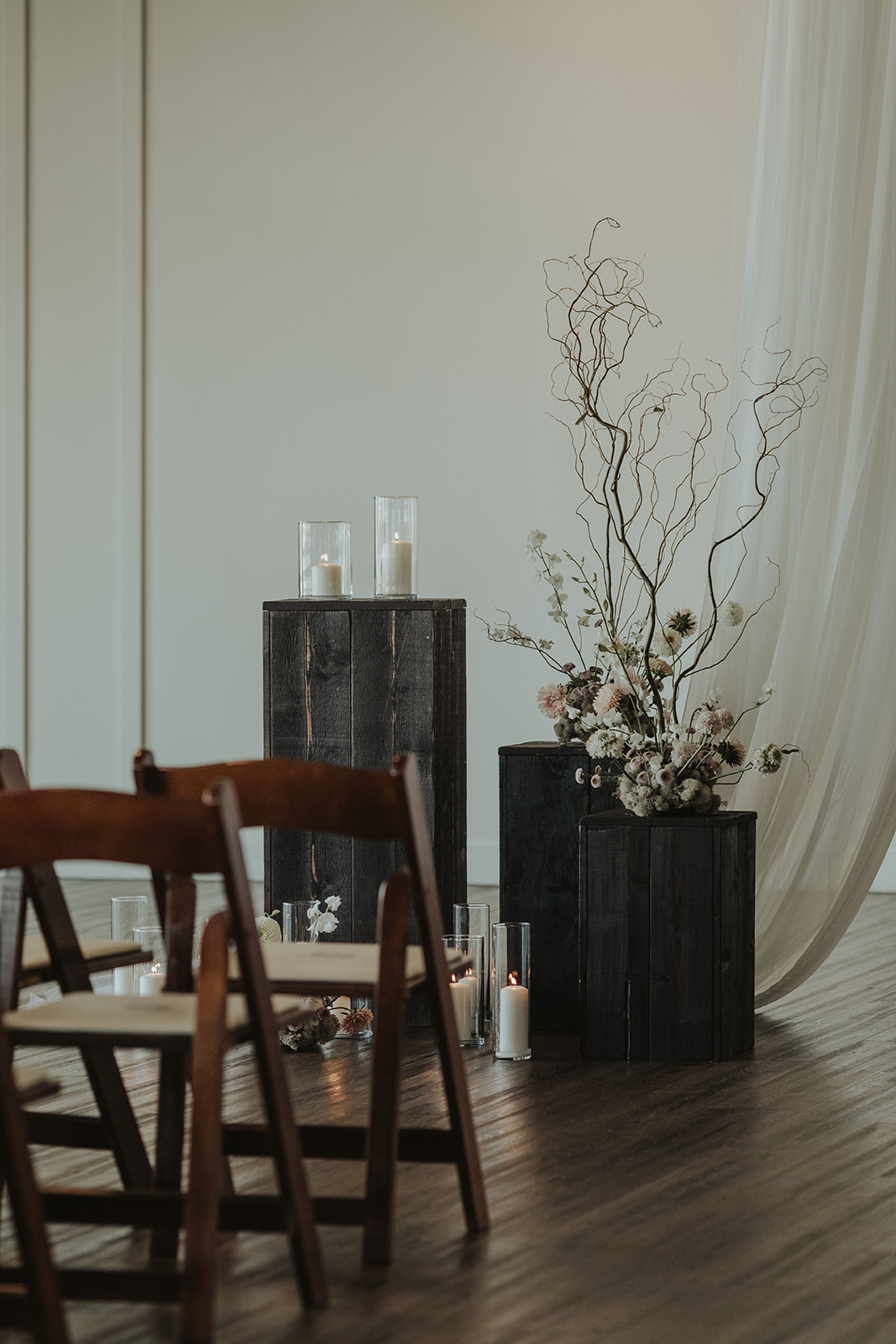 Moody wedding style at The Wallace in North Vancouver. Decorated with draped tapestry, and earthy, organic florals by The Flower Library.