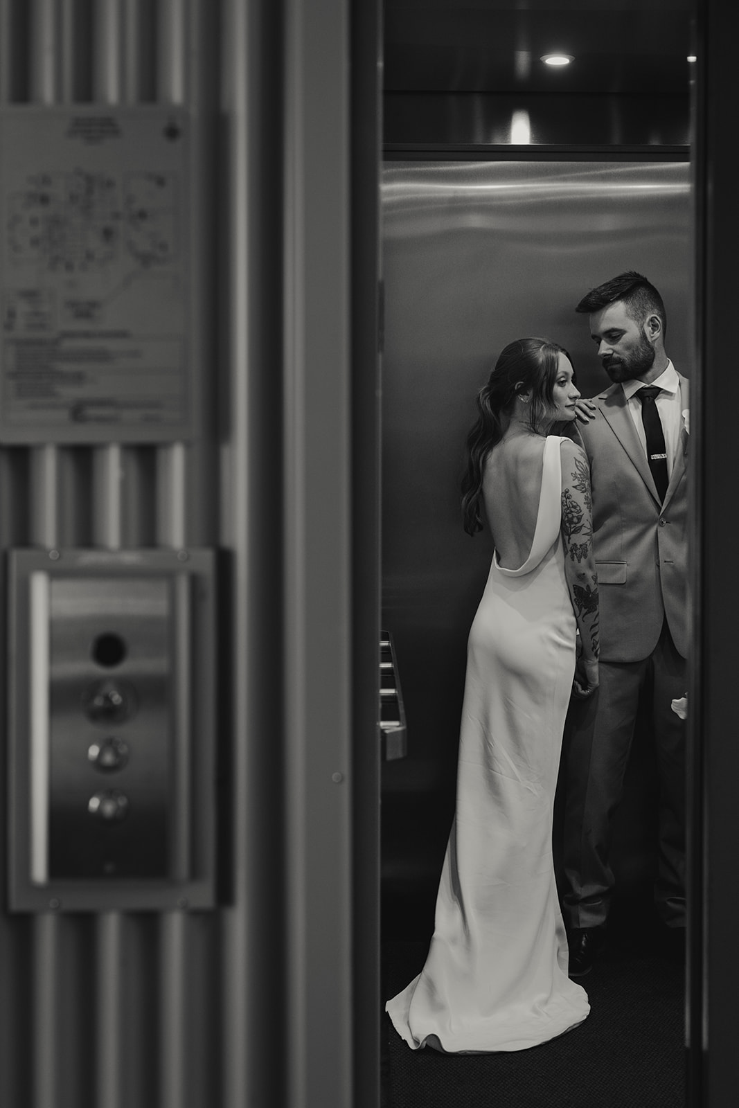 Moody bride and groom portrait captured by Jeff and Cat of The Apartment Photo. Bride wearing sleek satin gown with low back by Savannah Miller. 
