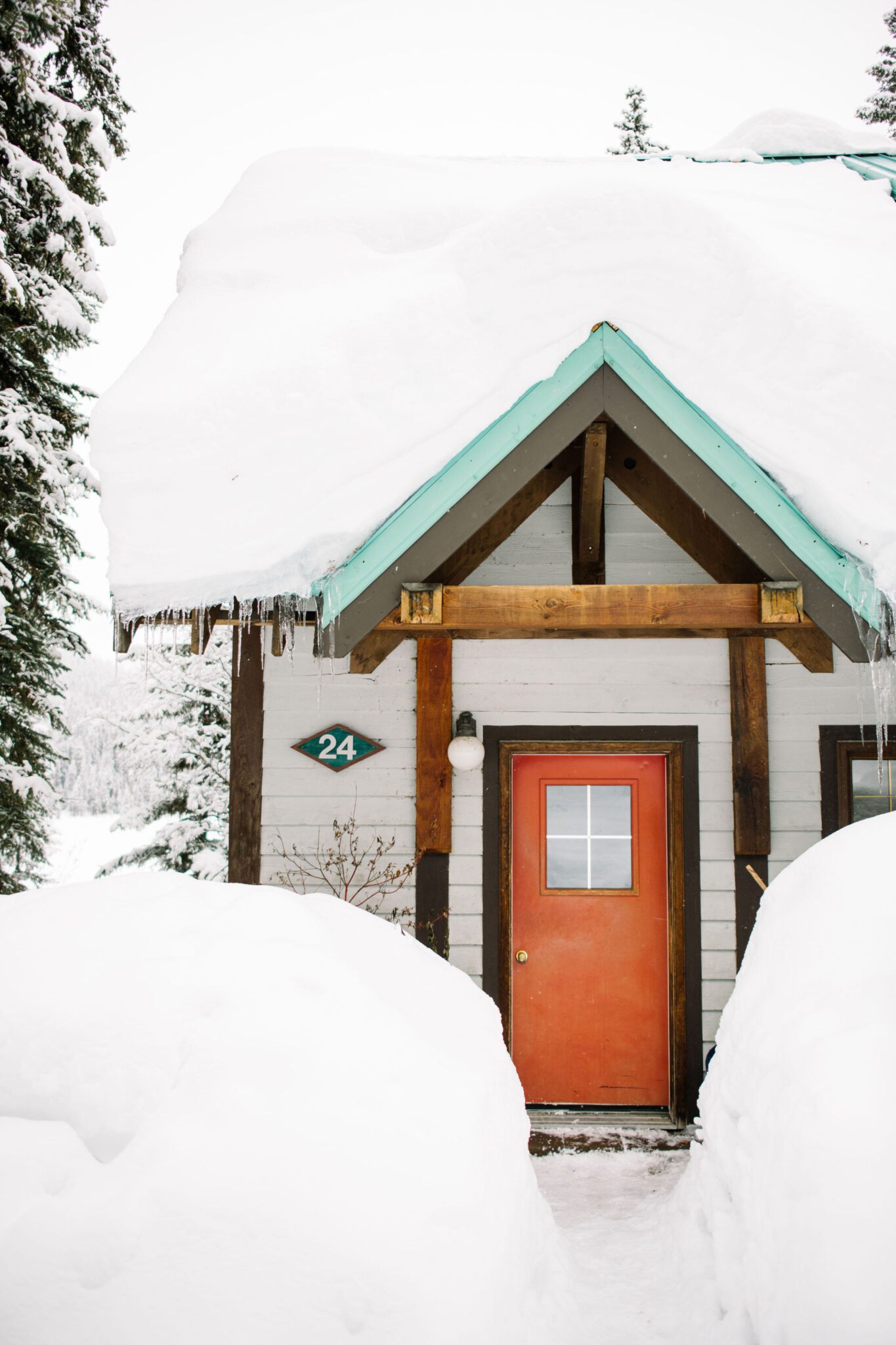 Cozy cabin captured at Emerald Lake Lodge in Alberta, covered in snow, winter wedding inspiration. 