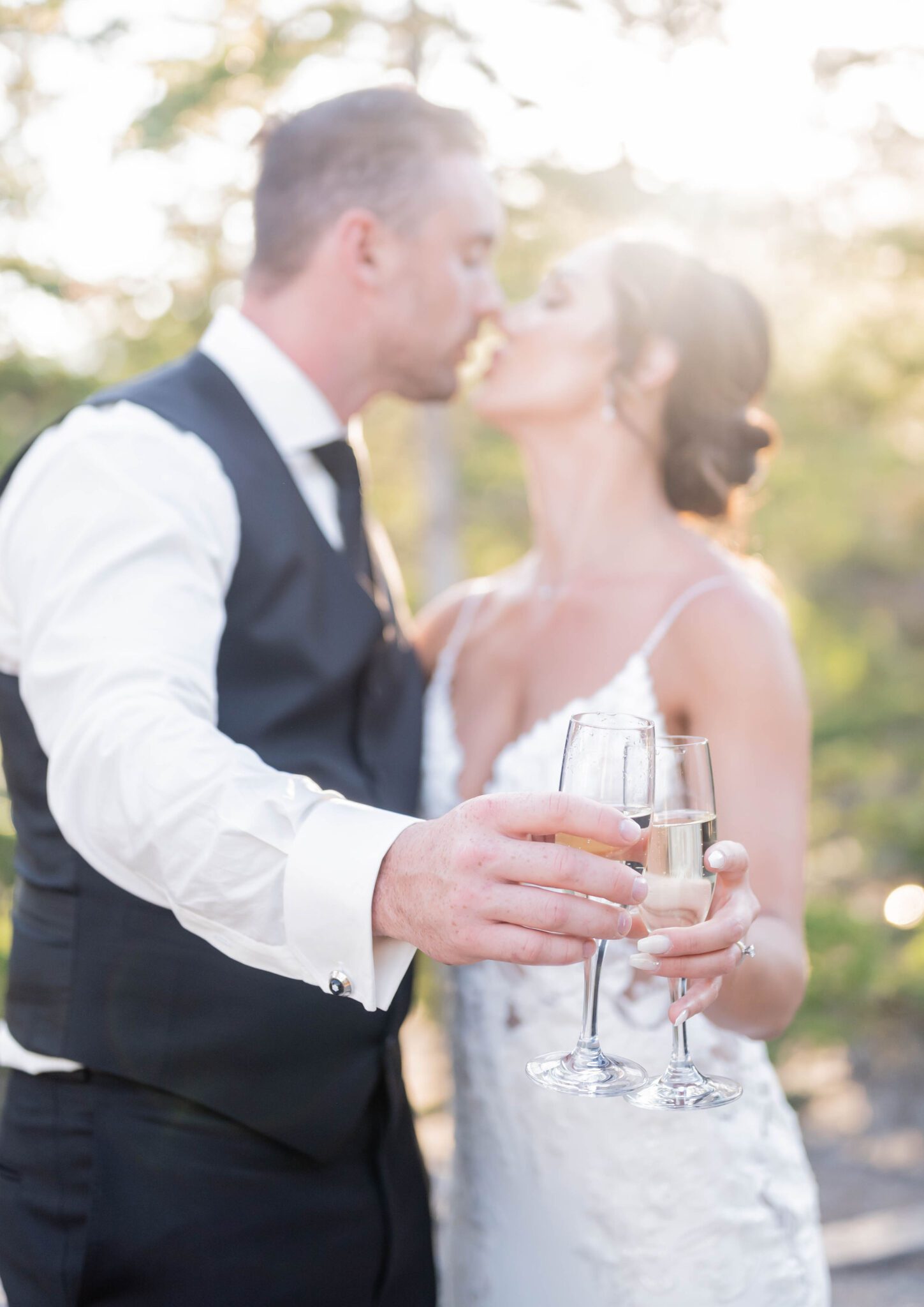 Bride and groom celebrating with champagne at their Banff Summer Wedding.