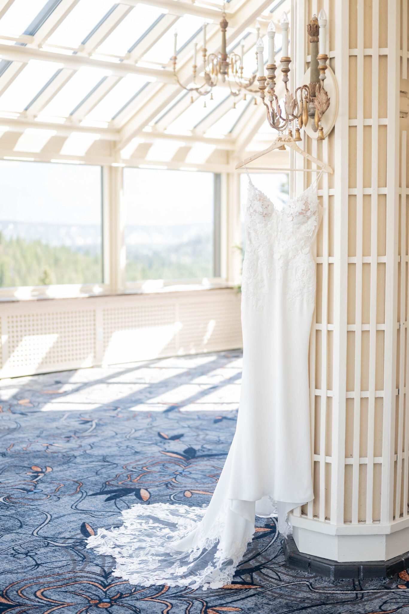 Bridal getting ready photos at Fairmont Banff Springs. Hanging lace bridal gown detail wedding dress photo