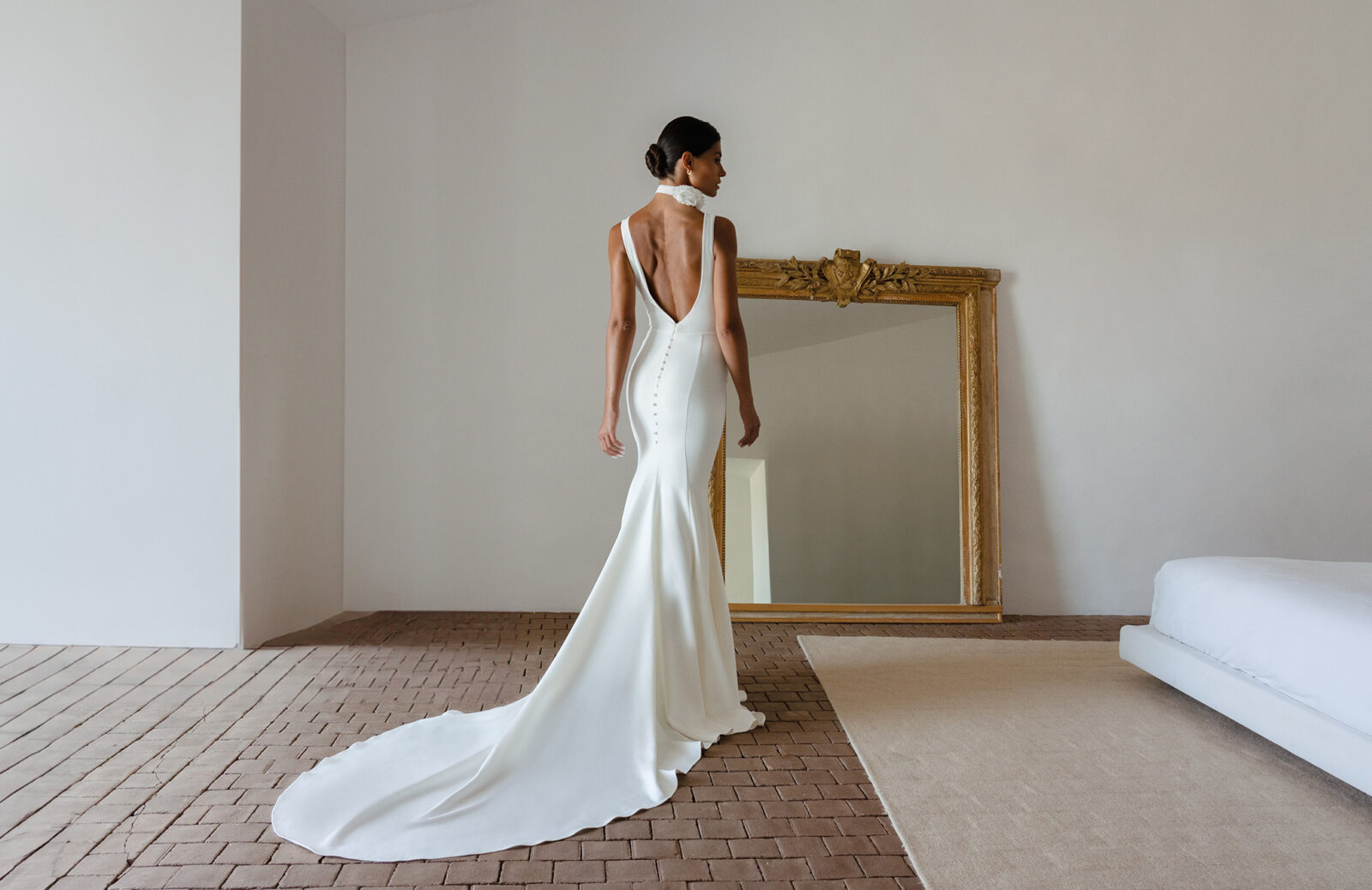 Bride wearing Old Hollywood elegant, clean-lined bridal gown with wide set straps and low back detail, designed by Grace Loves Lace.