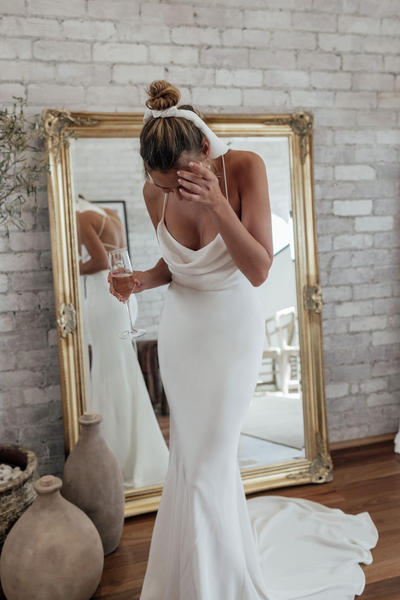 Bride wearing Old Hollywood elegant, clean-lined bridal gown with thin straps and draped neckline, designed by Grace Loves Lace.