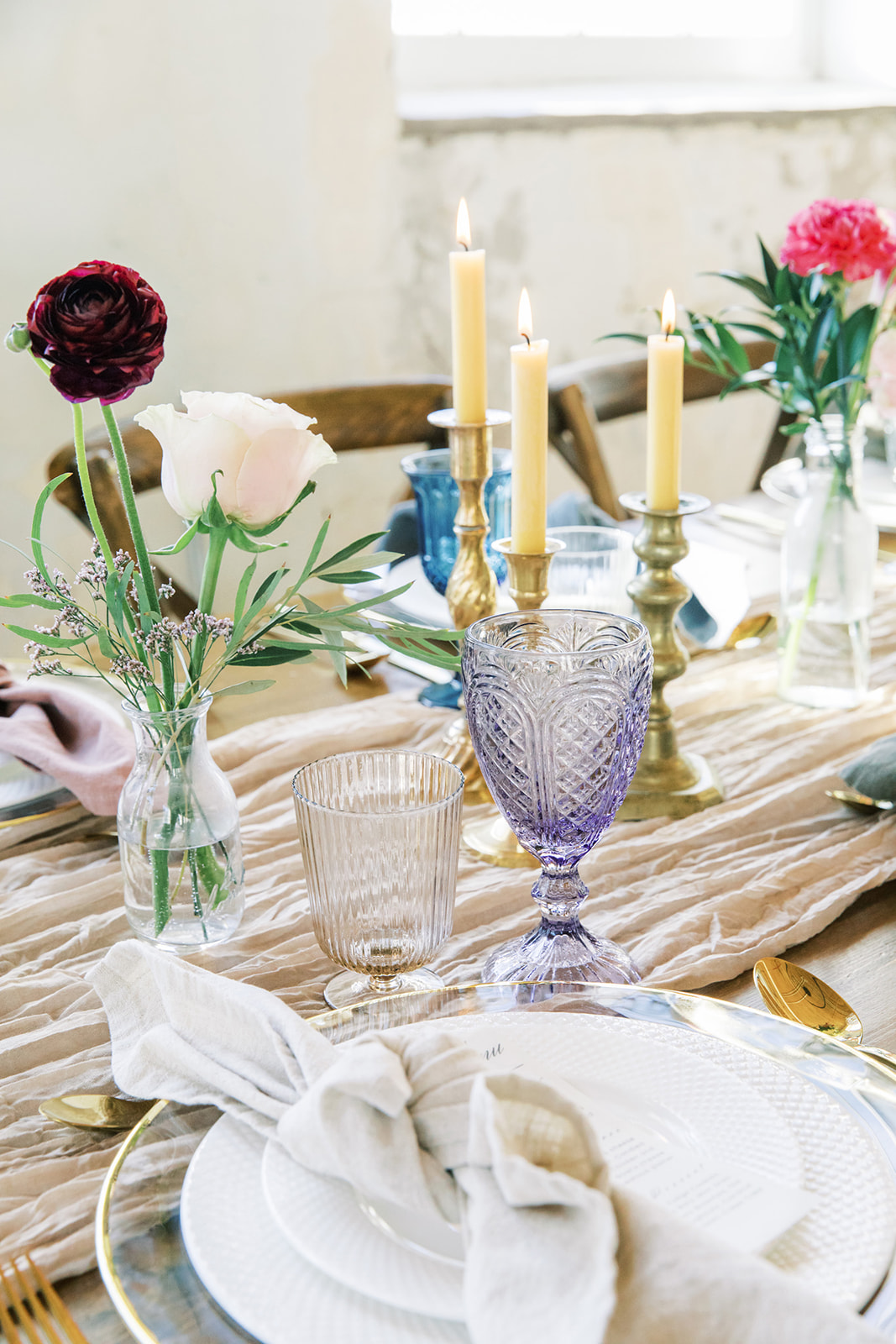 Playful colour palette, romantically styled wedding reception inspiration at Local Market YQR. Featuring hanging florals by Rose & Vine, vintage candelabras, and royal blue glassware. 