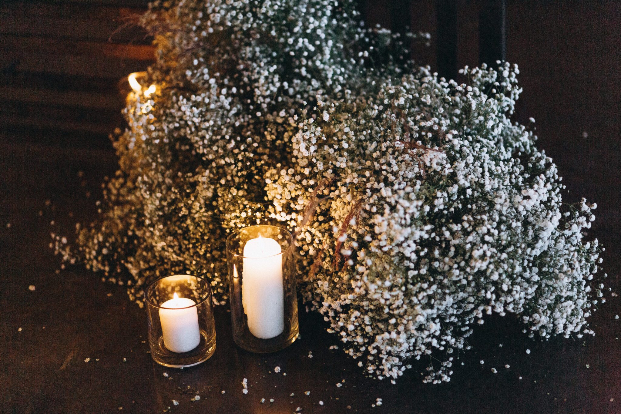 Modernized and updated take on a baby's breath installation for the ceremony arch at this Country Chic style wedding inspiration, ceremony arch inspiration with baby's breath and candles