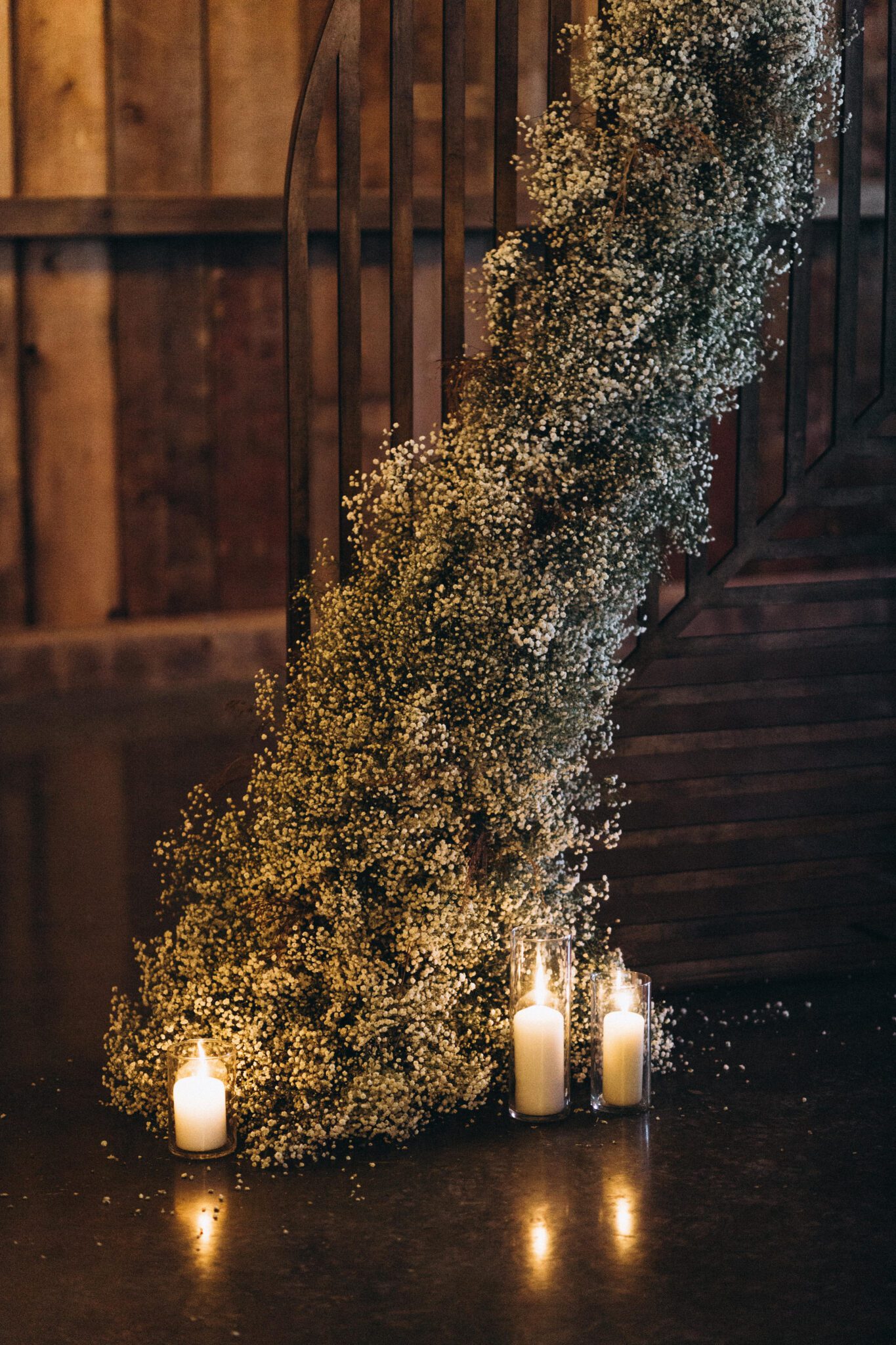 Modernized and updated take on a baby's breath installation for the ceremony arch at this Country Chic style wedding inspiration, ceremony arch inspiration with candles