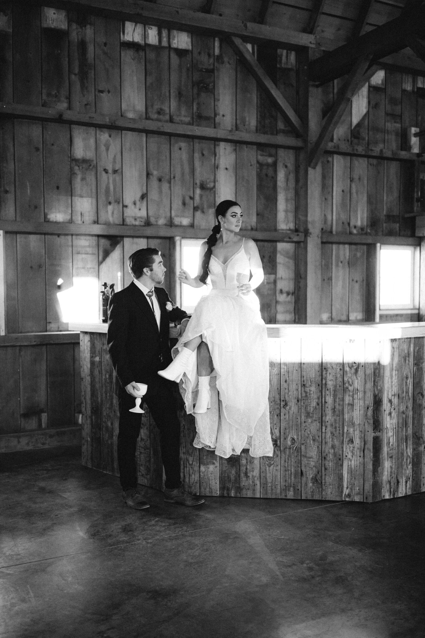 Wedding Inspiration With An Updated Take on Country Chic Wedding Style at Countryside Barn in Lethbridge Alberta, black and white photography of bride and groom, vintage wedding attire, bride and groom at wedding bar, portraits