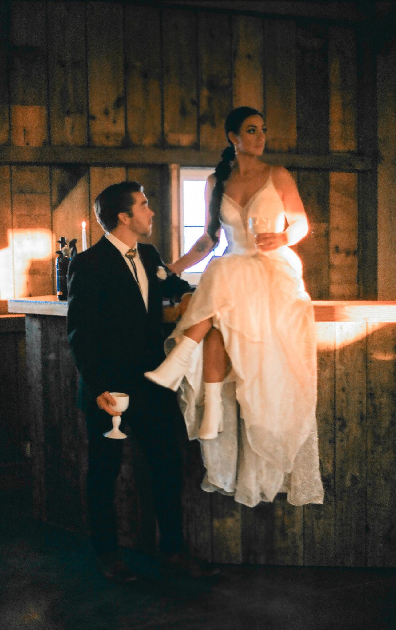 Wedding Inspiration With An Updated Take on Country Chic Wedding Style at Countryside Barn in Lethbridge Alberta, warm romantic wedding photography of bride and groom, vintage wedding attire, bride and groom at wedding bar