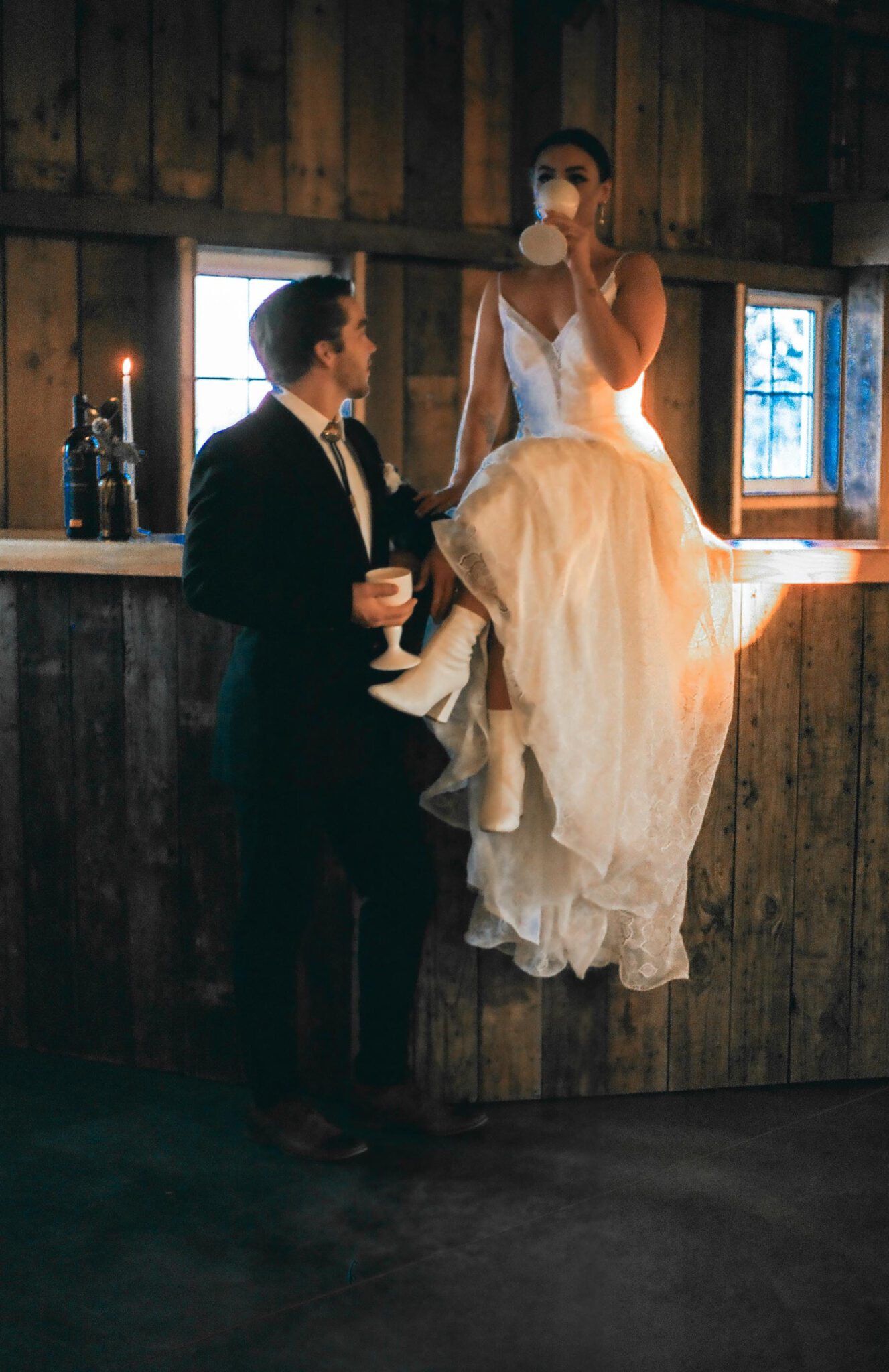Wedding Inspiration With An Updated Take on Country Chic Wedding Style at Countryside Barn in Lethbridge Alberta, warm romantic wedding photography of bride and groom, vintage wedding attire, bride and groom at wedding bar