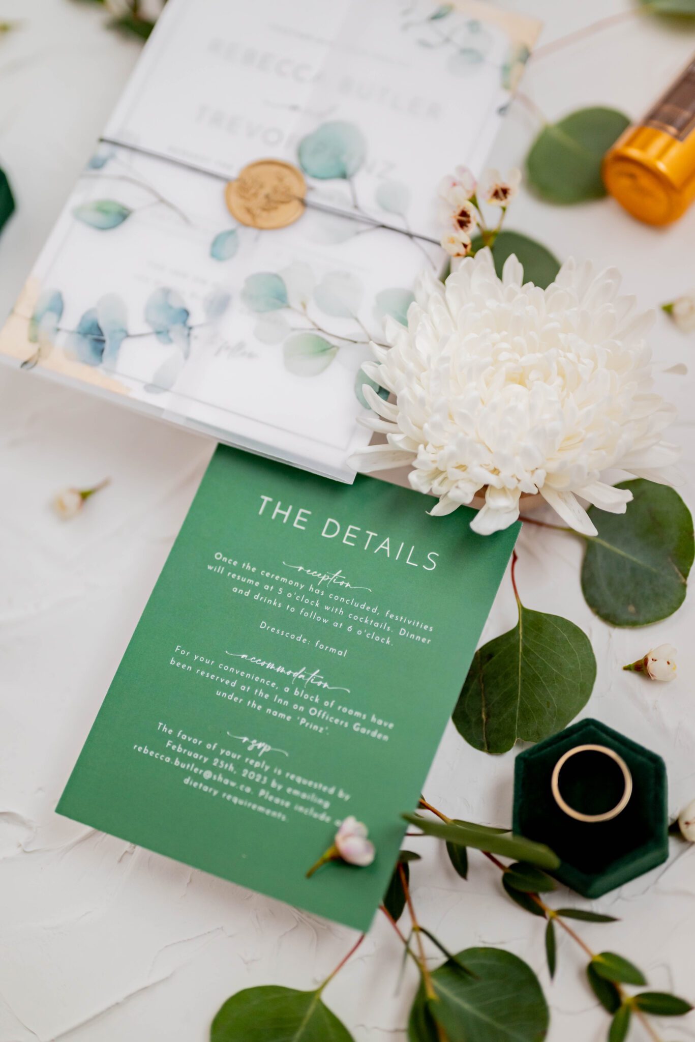 Close up detail photo of green wedding invitation suite. Flatlay photography inspiration. 