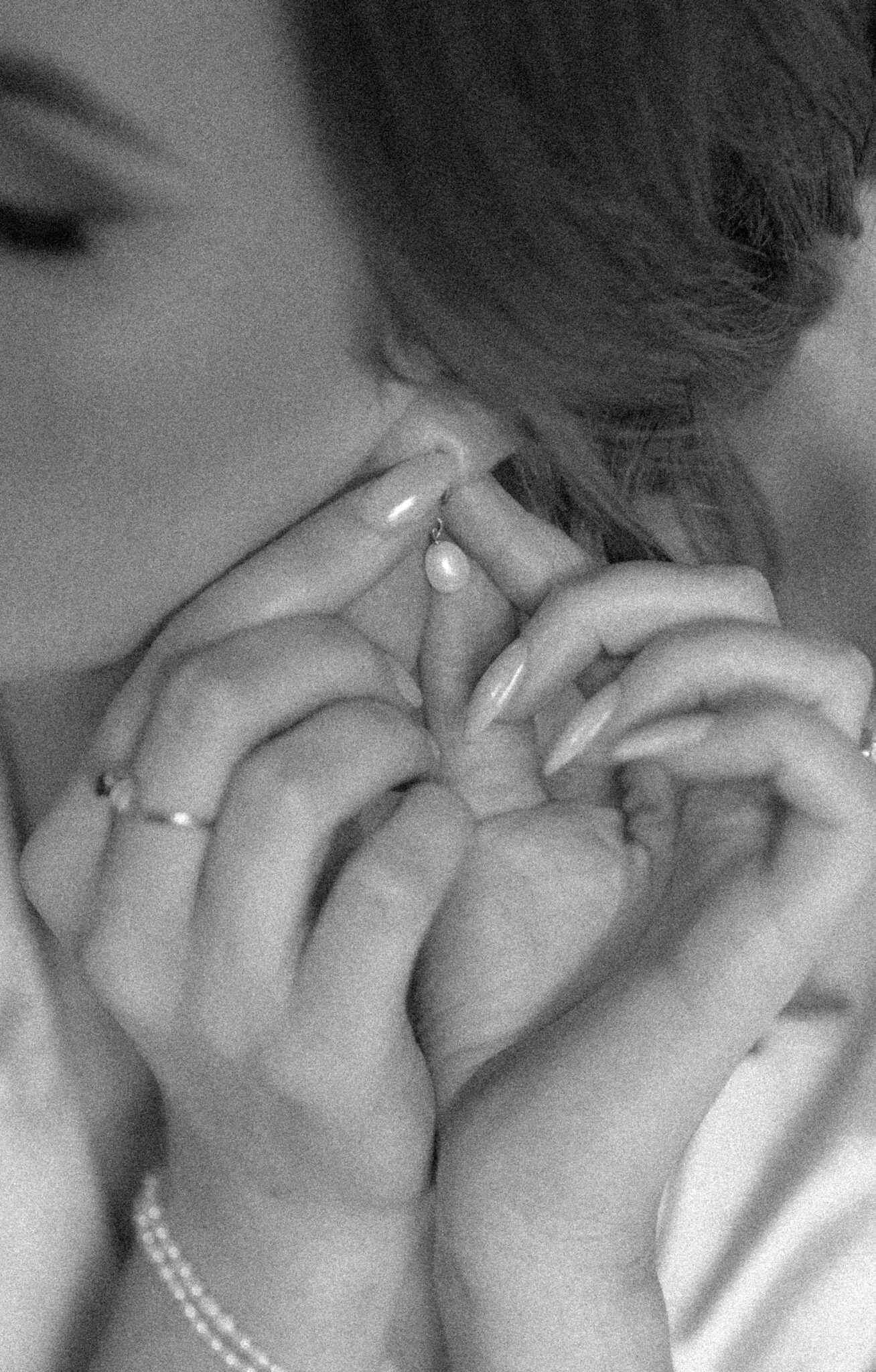 Close up, black and white portrait of bride putting on her pearl drop earrings, getting ready photo inspiration. 