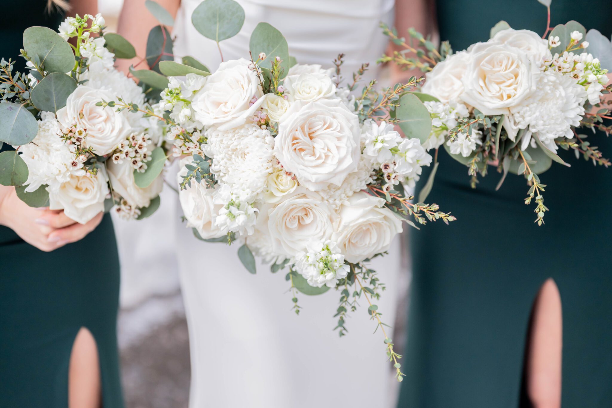 Classic colour palette of white florals and greenery in these bride and bridesmaid bouquets, designed by Floral Chix.