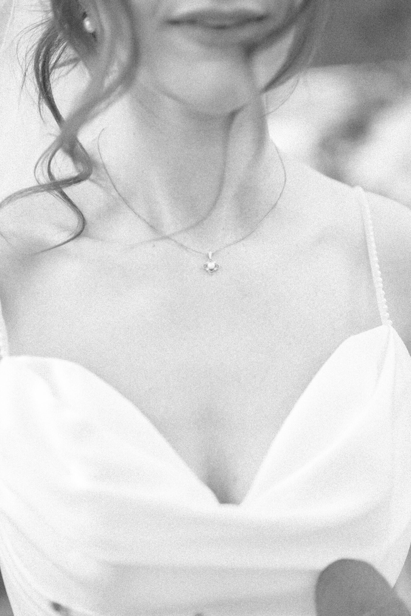 Intimate, black and white portrait of bride's dress details and elegant necklace, bridal portrait inspiration, black and white photo inspiration. 