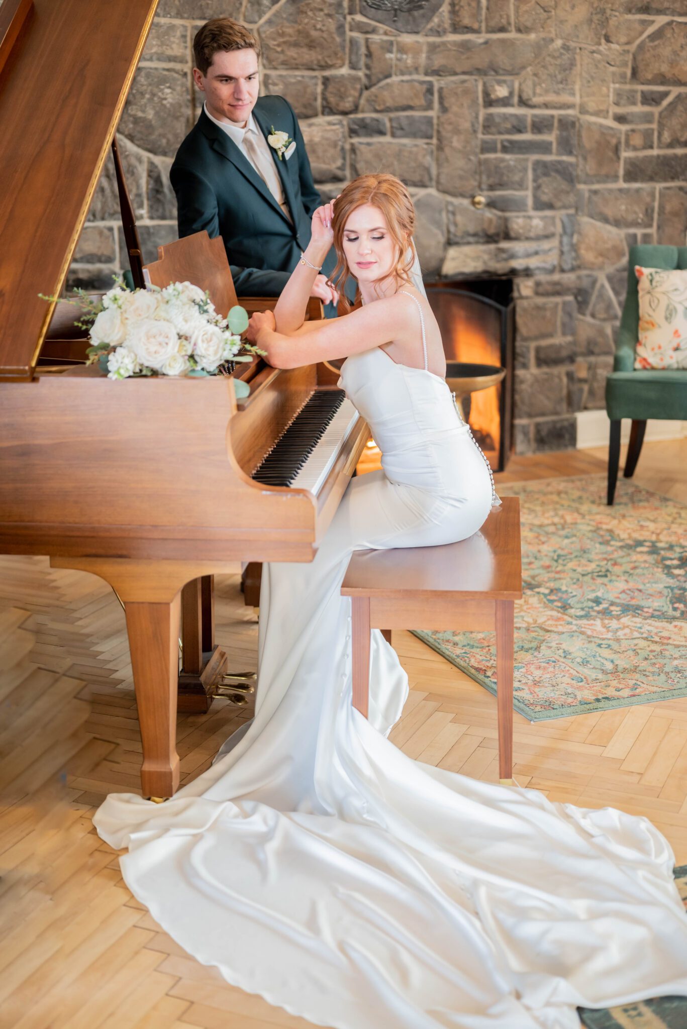 Bride and groom posed in front of elegant grand piano at the Inn on Officer's Garden wedding venue, wedding portrait inspiration. Classic Calgary wedding inspiration. 