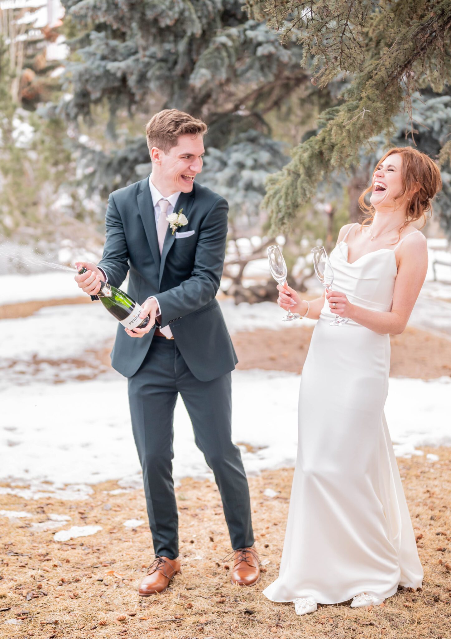 Bride and groom celebrate by popping a bottle of champagne, after their elegant wedding ceremony, classic Calgary wedding inspiration. 