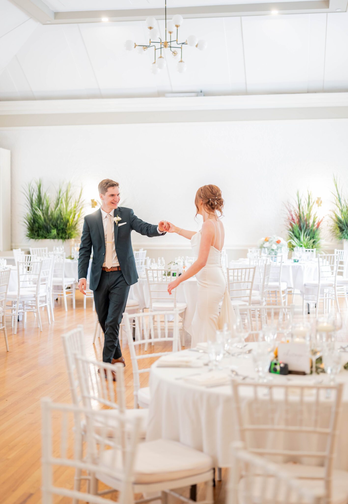 Bride and groom enjoy a private first dance together before their guests enter the bright, elegant reception room, classic Calgary wedding inspiration. 