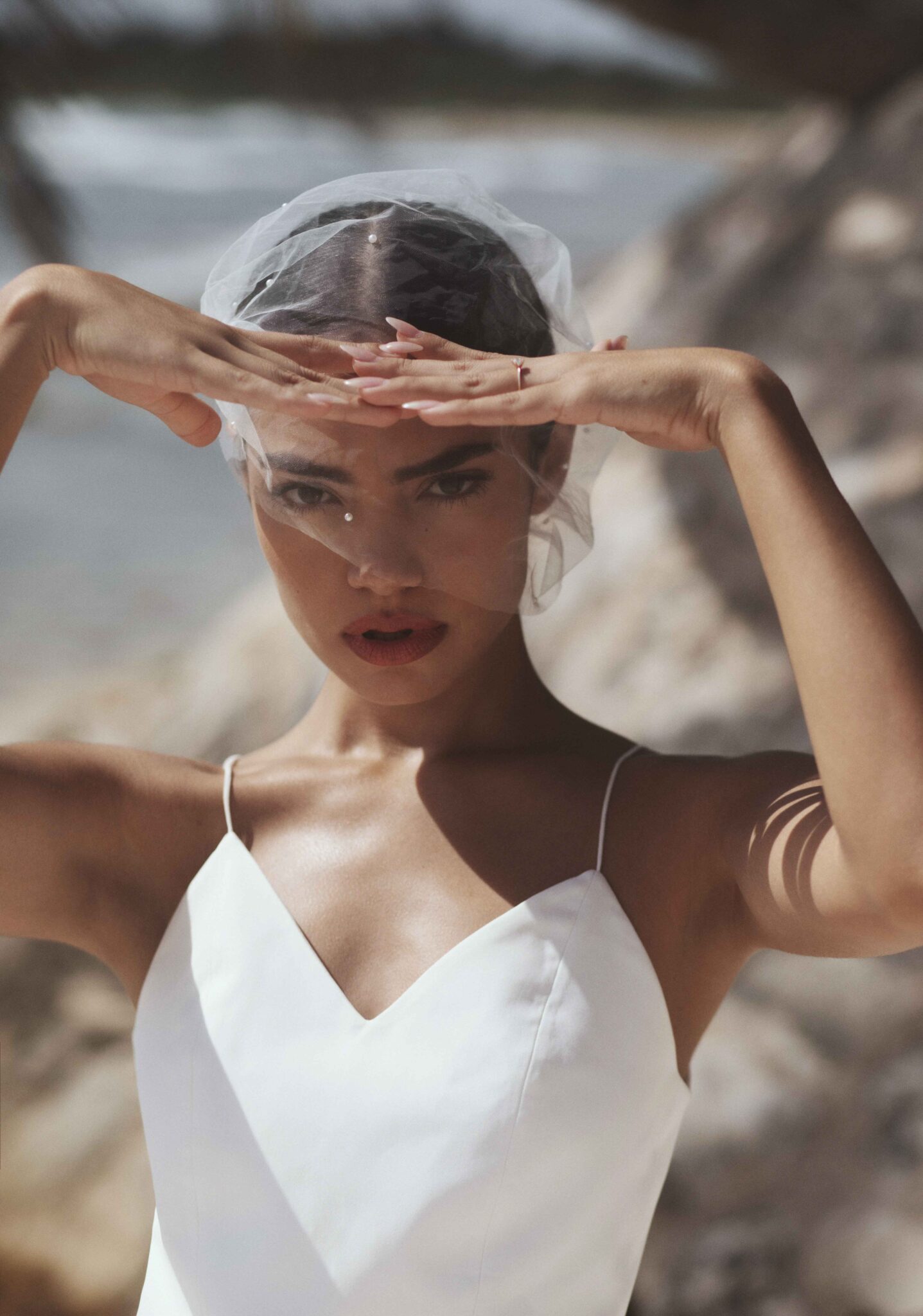 Close up, seaside wedding portrait of bride in Mexico, featuring short veil covering the bride's head, Storm-inspired bridal inspiration from Tempête with an effortless & free-spirited nature. 