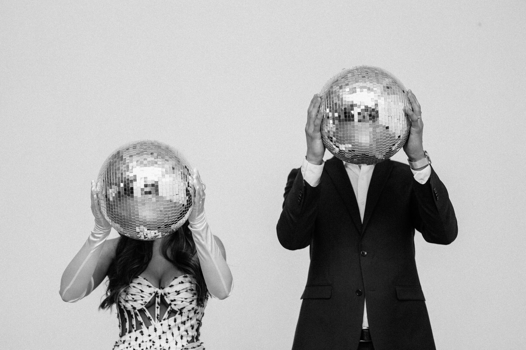 Bride and groom holding disco balls at retro-inspired wedding at The Brownstone in Calgary, Alberta.