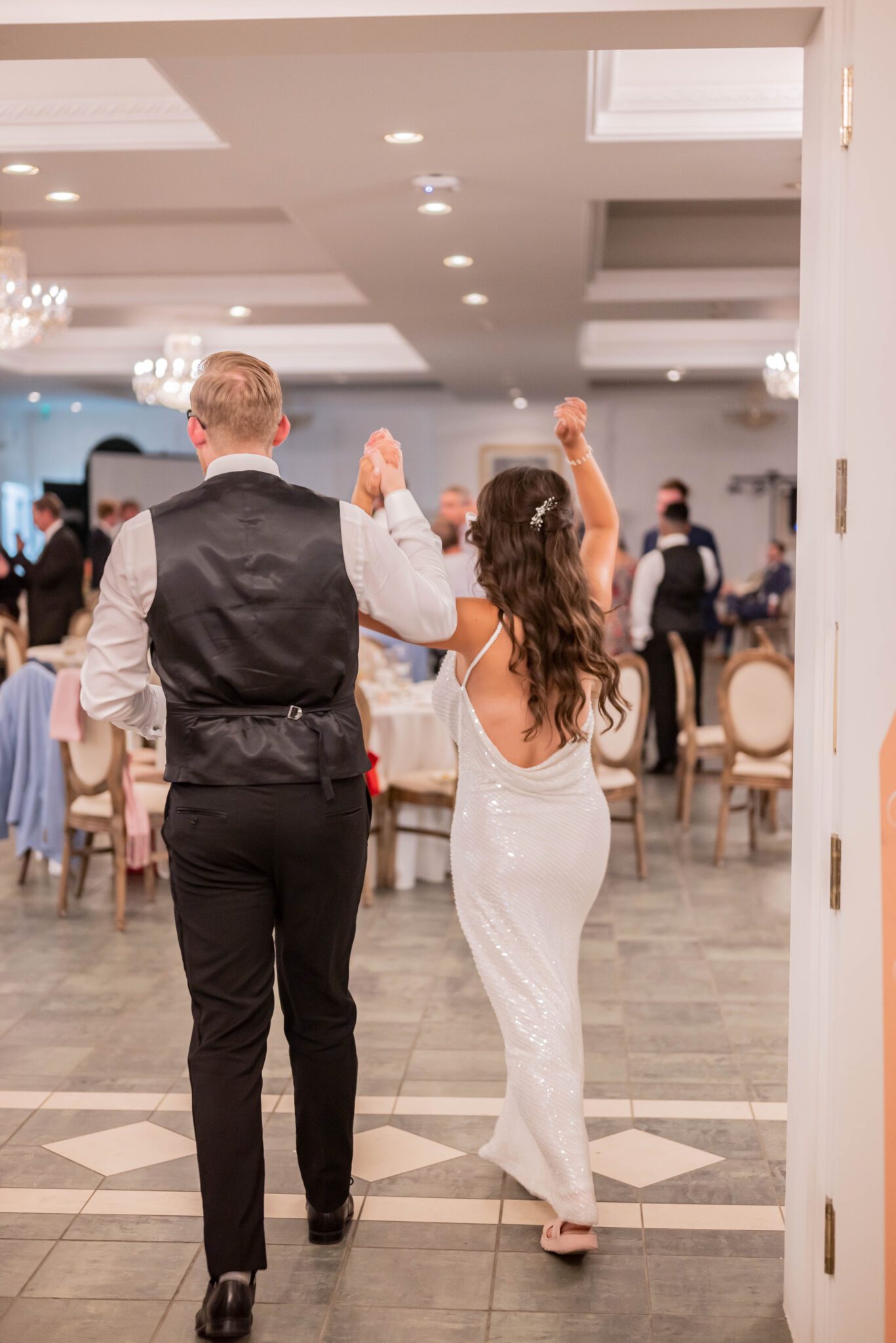 Bride changes into a sequin, backless dress and the couple enters their reception room in their second look at Spruce Meadows.