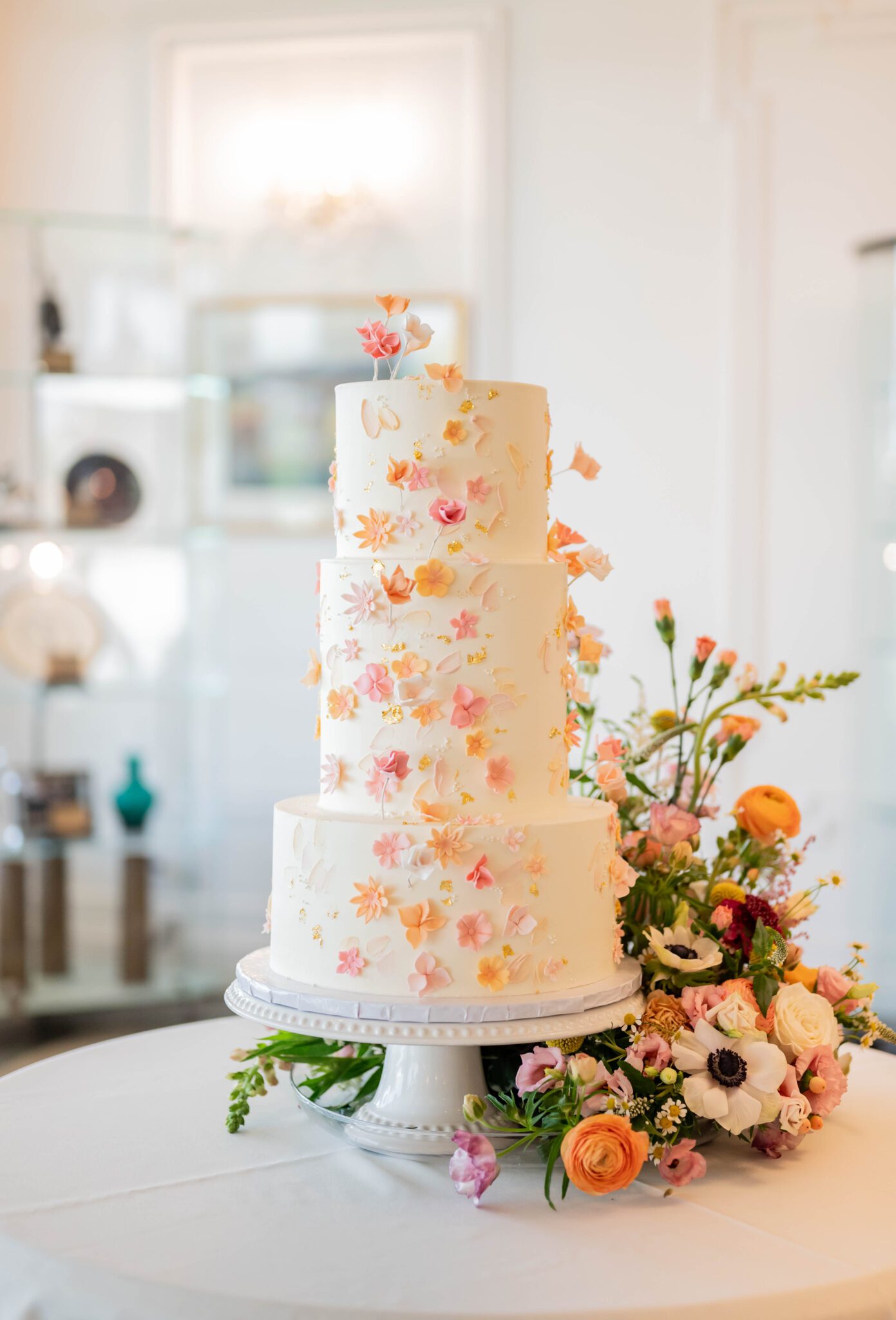 Garden party-inspired, two-tiered wedding cake, with floral appliqus