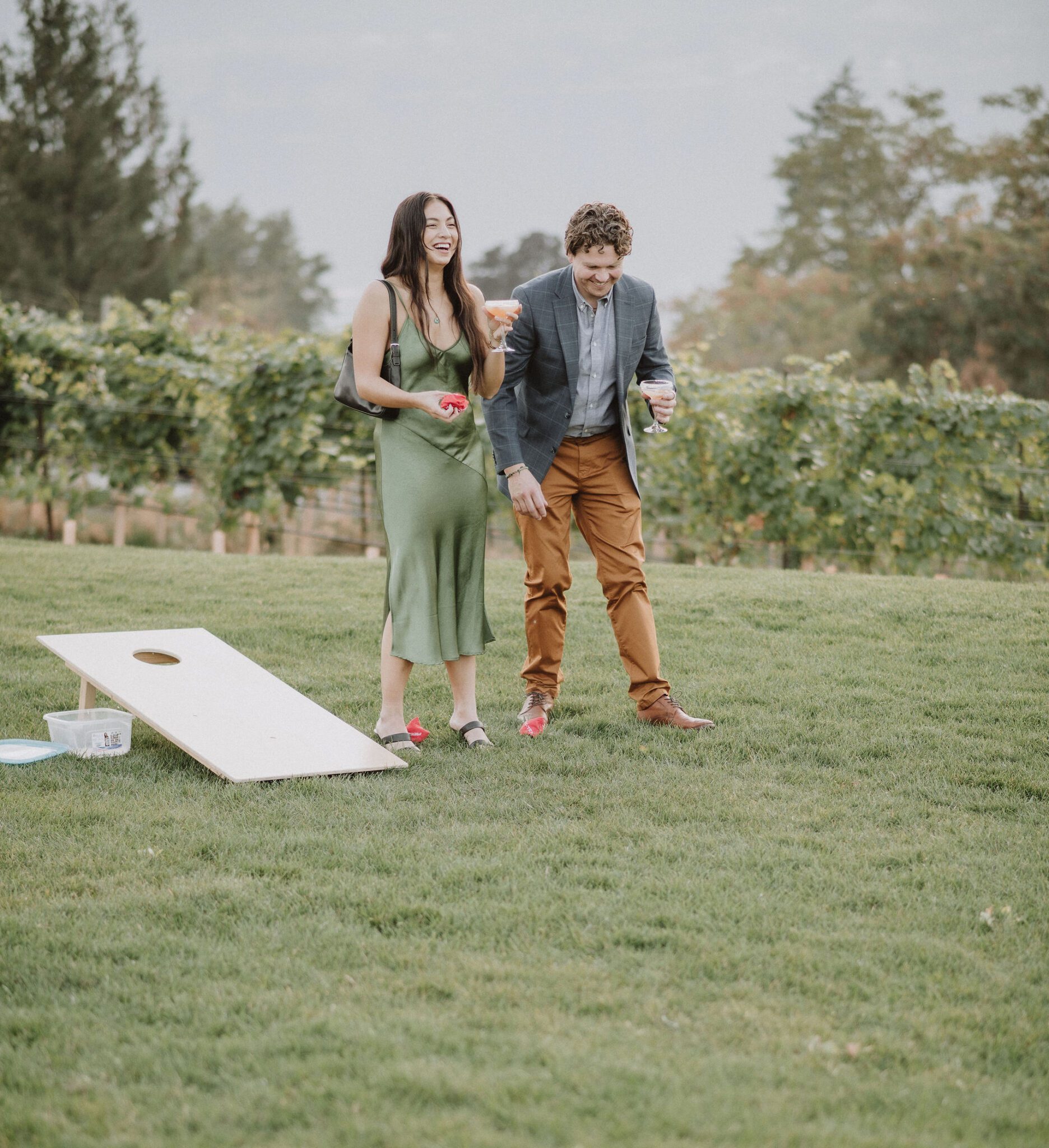 Intimate vineyard wedding reception details and captured candid moments with guests, featuring lawn games and entertainment.