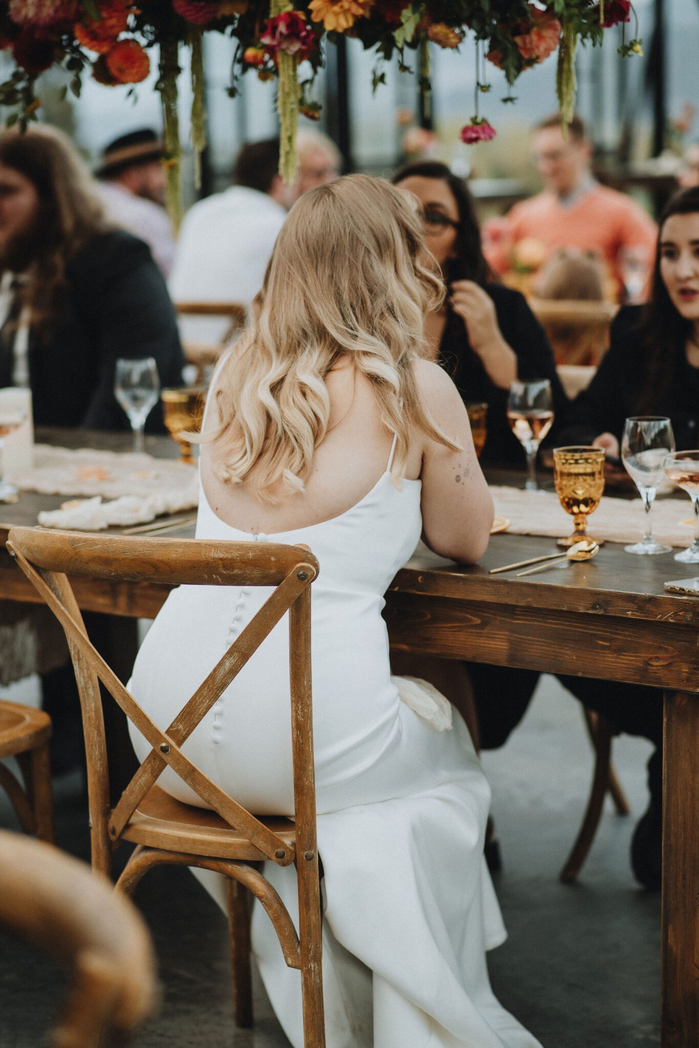 Bride interacting with her guests at their intimate vineyard wedding reception. 