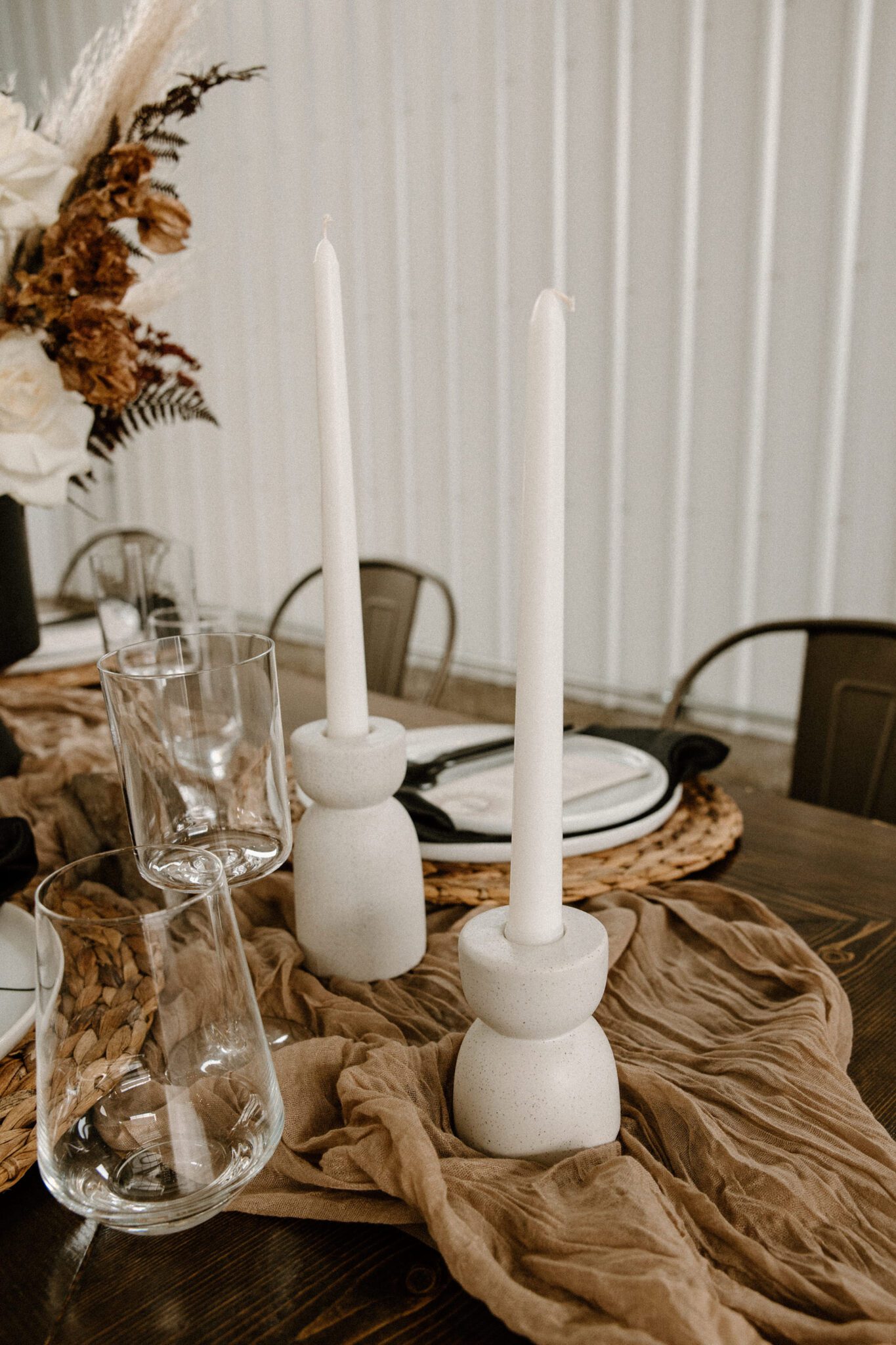 Rich brown textures and tones featured in this tablescape at 52 North Venue, featuring cream-coloured taper candles, warm and moody wedding inspiration. 