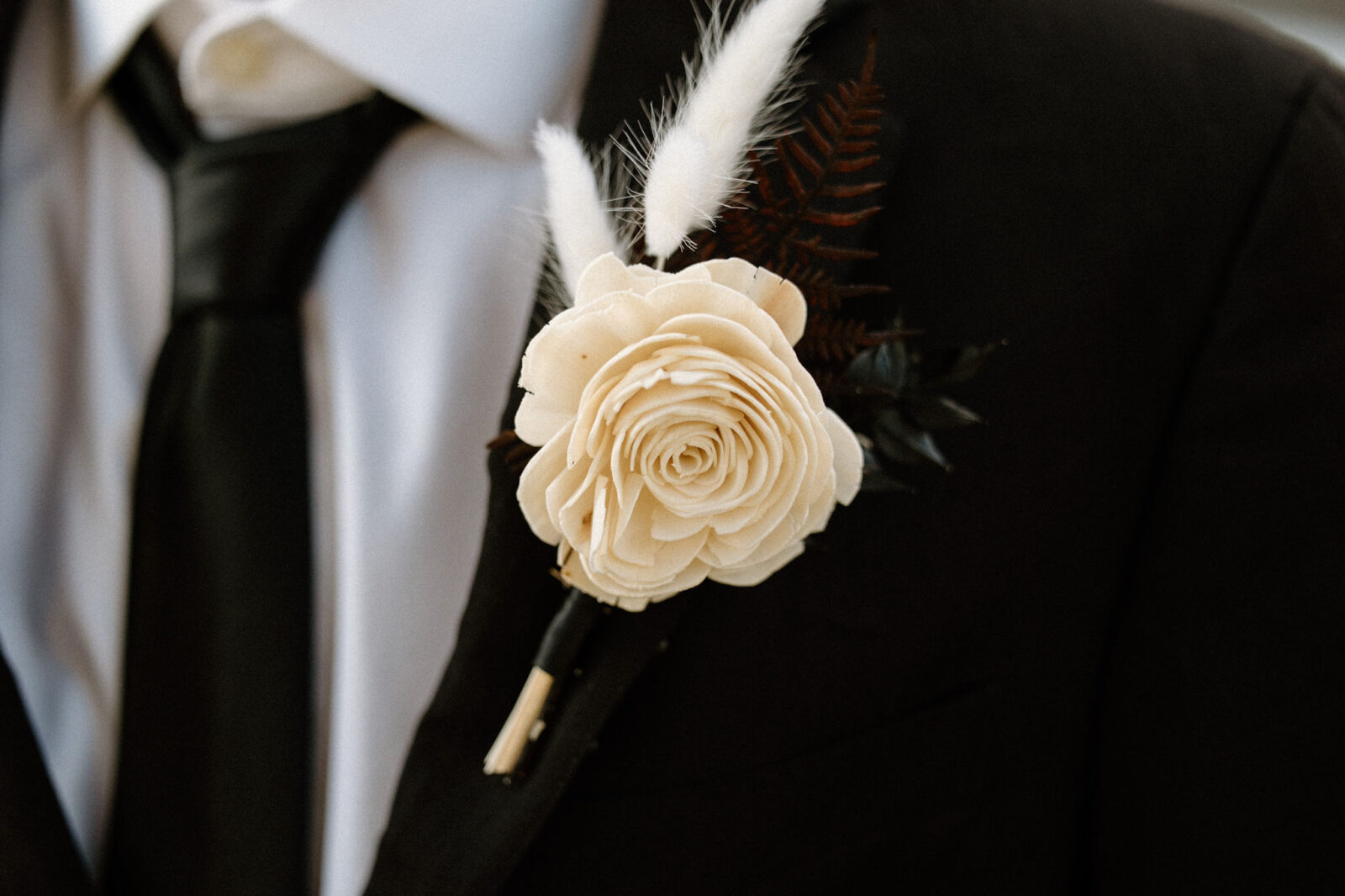 Portrait of groom's boutonniere, warm and moody wedding inspiration. 