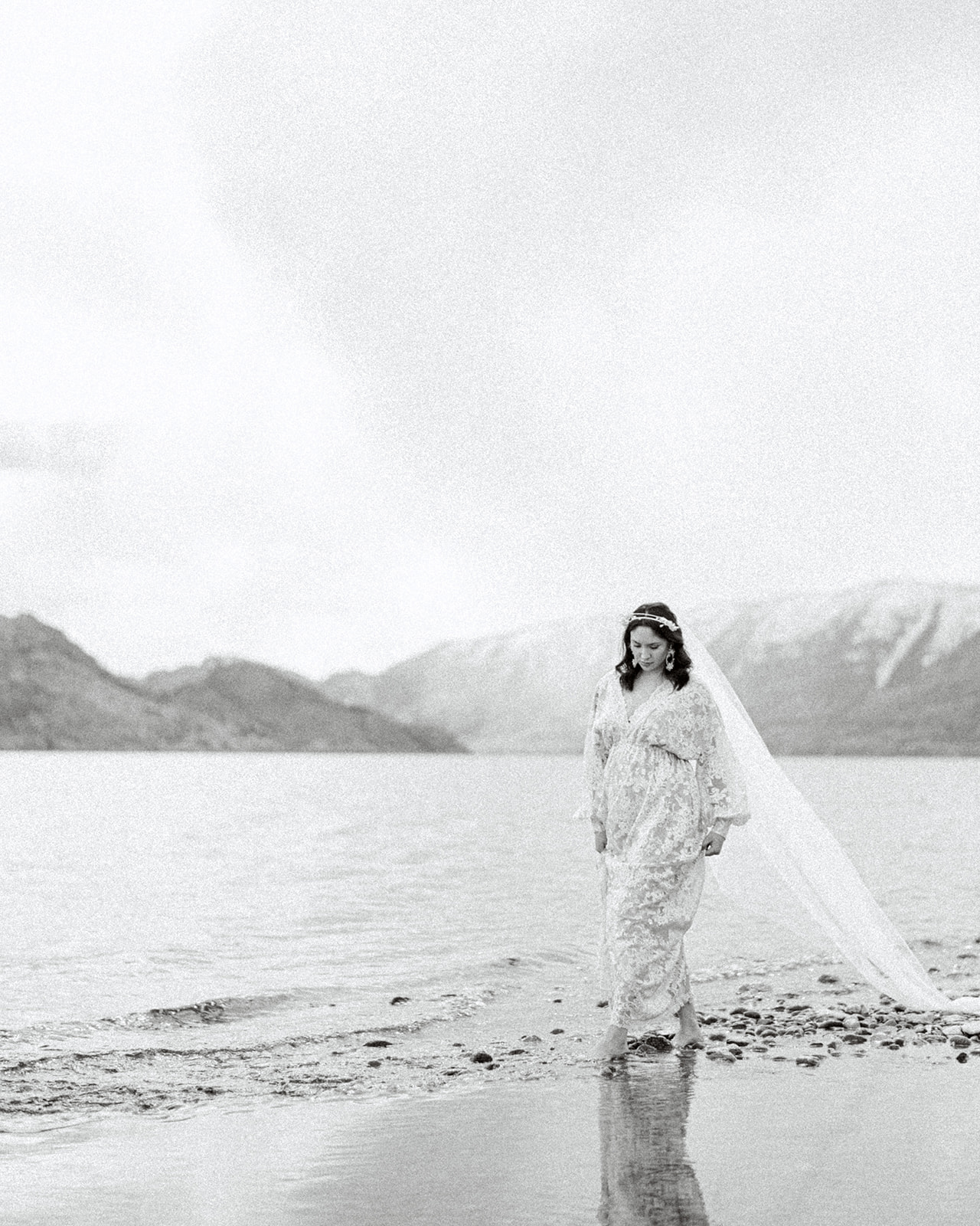 Stunning bridal portrait in an ethereal bridal editorial on Lake Okanagan, BC, featured on Brontë Bride. Unique styled elements that blend seamlessly with the majestic backdrop of the Canadian Rockies.