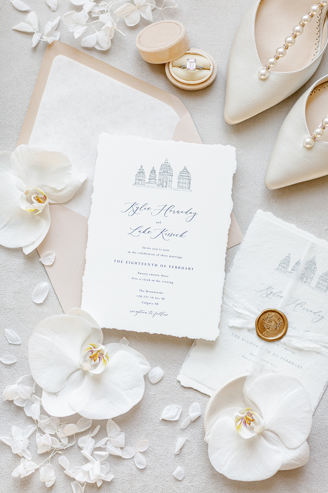 Clean and sophisticated white and cream wedding details captured by Revel Photography & Films. Invitation paper suite custom designed by Pink Umbrella Invites. 
