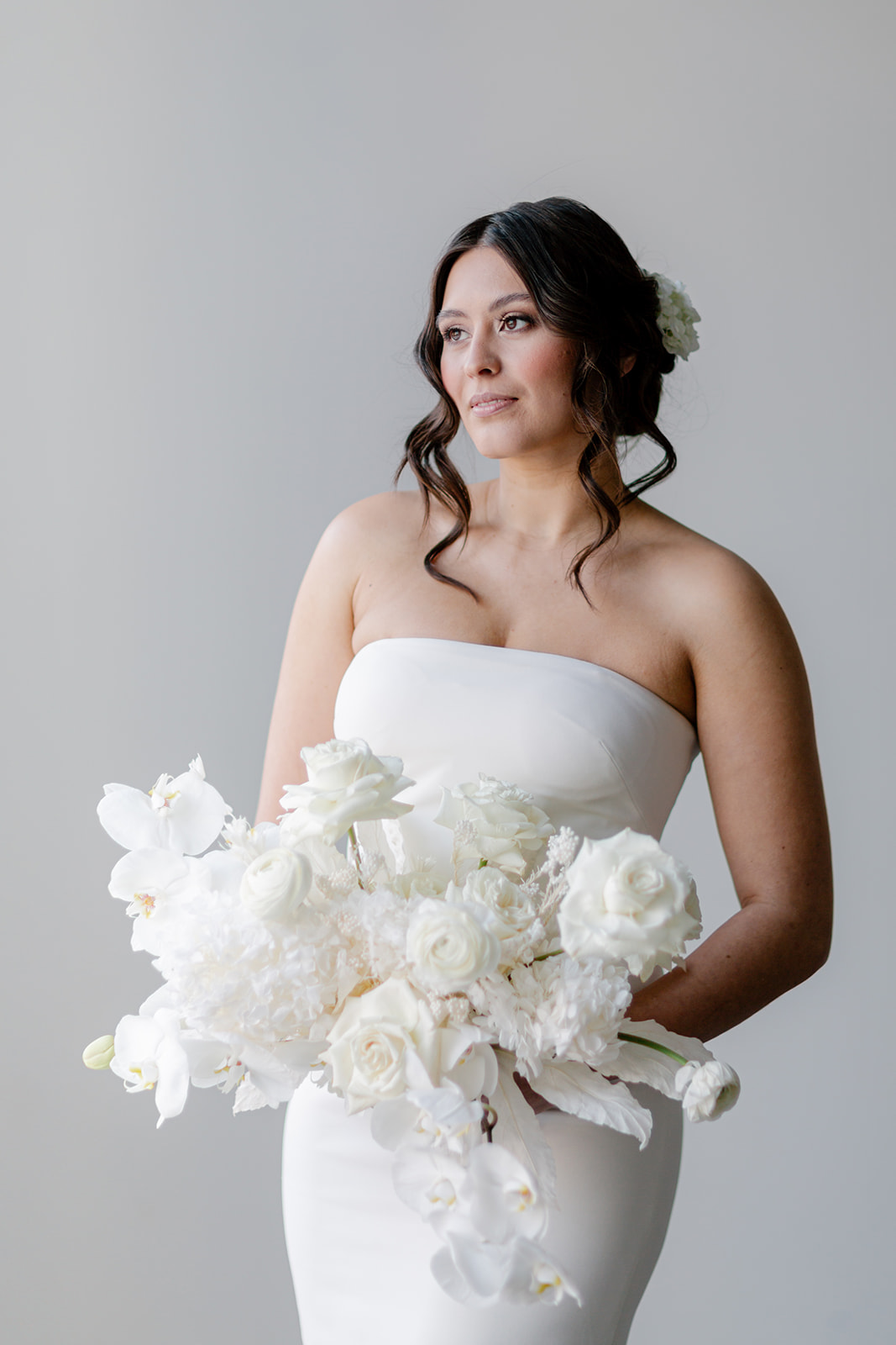 Bride wearing sleek and elegant gown by Theia at The Brownstone in Calgary, Alberta. Bridal hair by Leeanne Pilkington Makeup Artistry.
