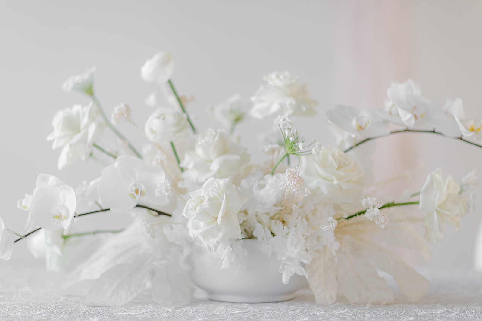 Sophisticated white bridal floral centrepieces designed by Hen & Chicks in Calgary, Alberta. 