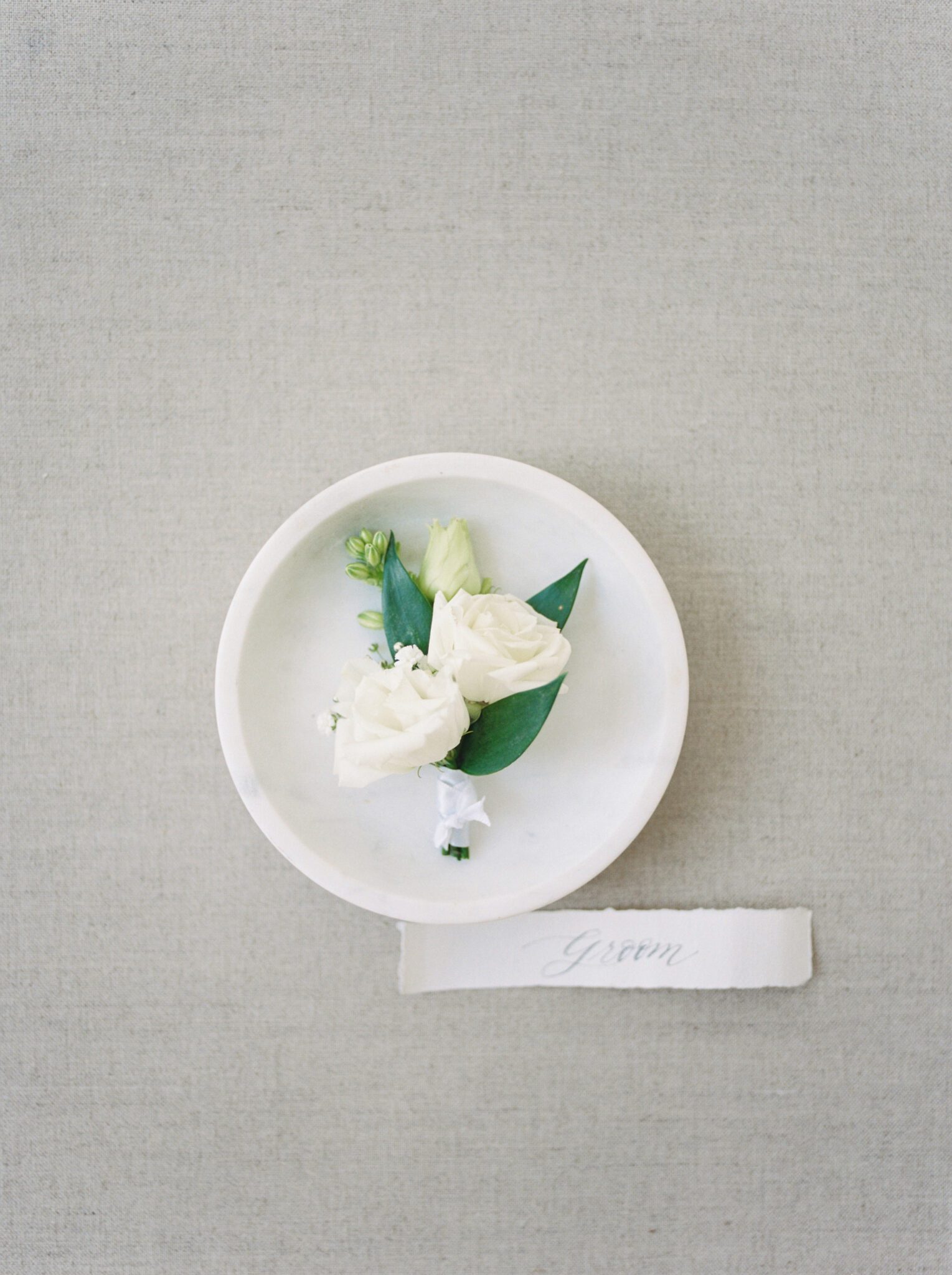 Classic white rose groom boutonniere from Lovella Lifestyle.